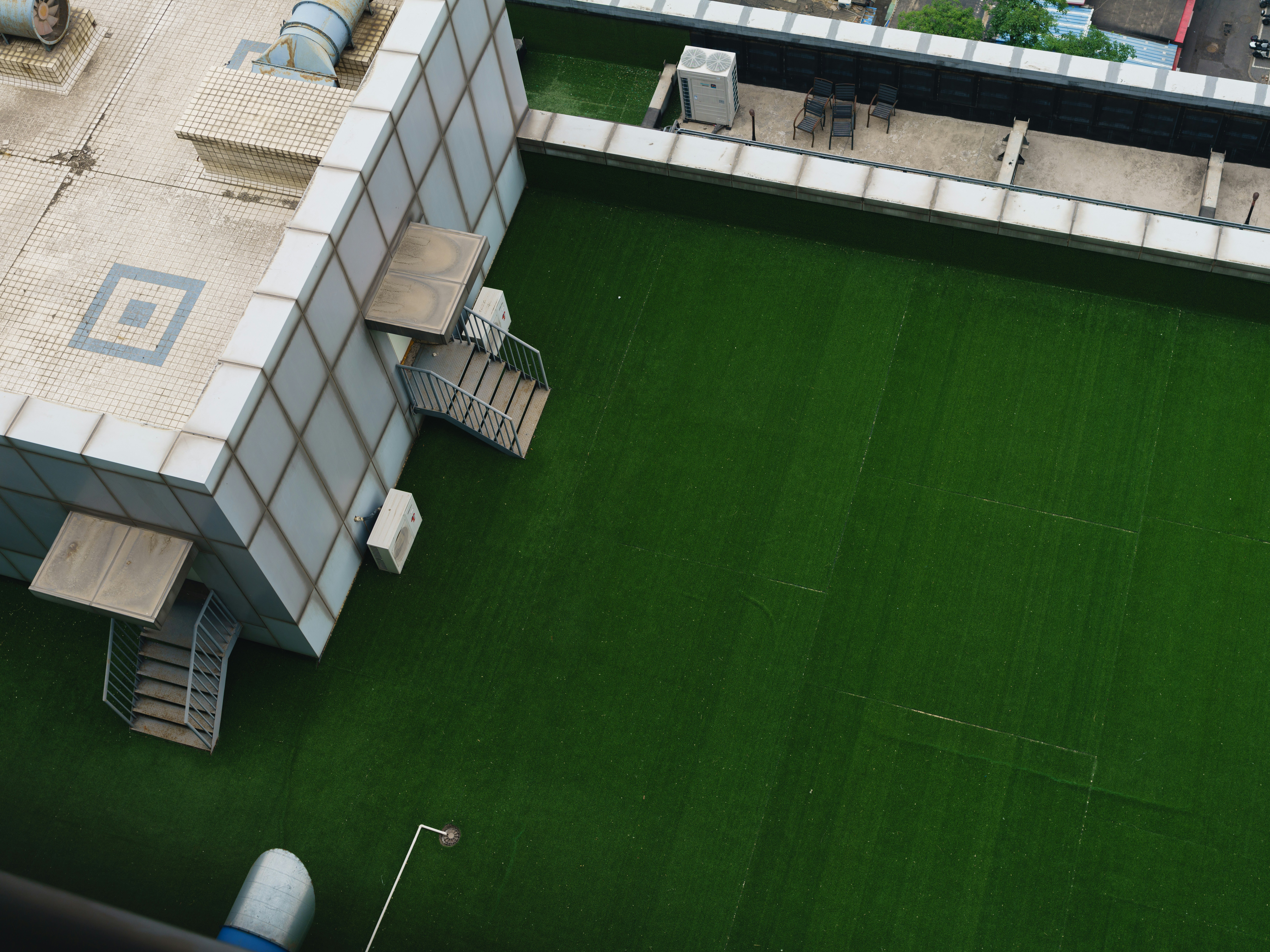 Rooftop with green artificial turf and building structure