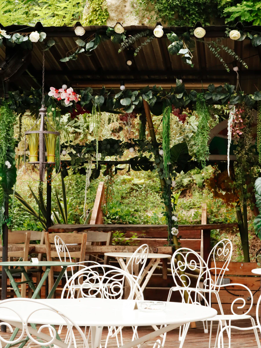 A planted club terrace, pergola and mature greenery over seating.
