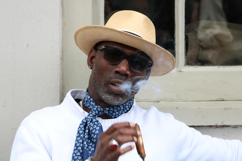 distinguished man in a hat and sunglasses