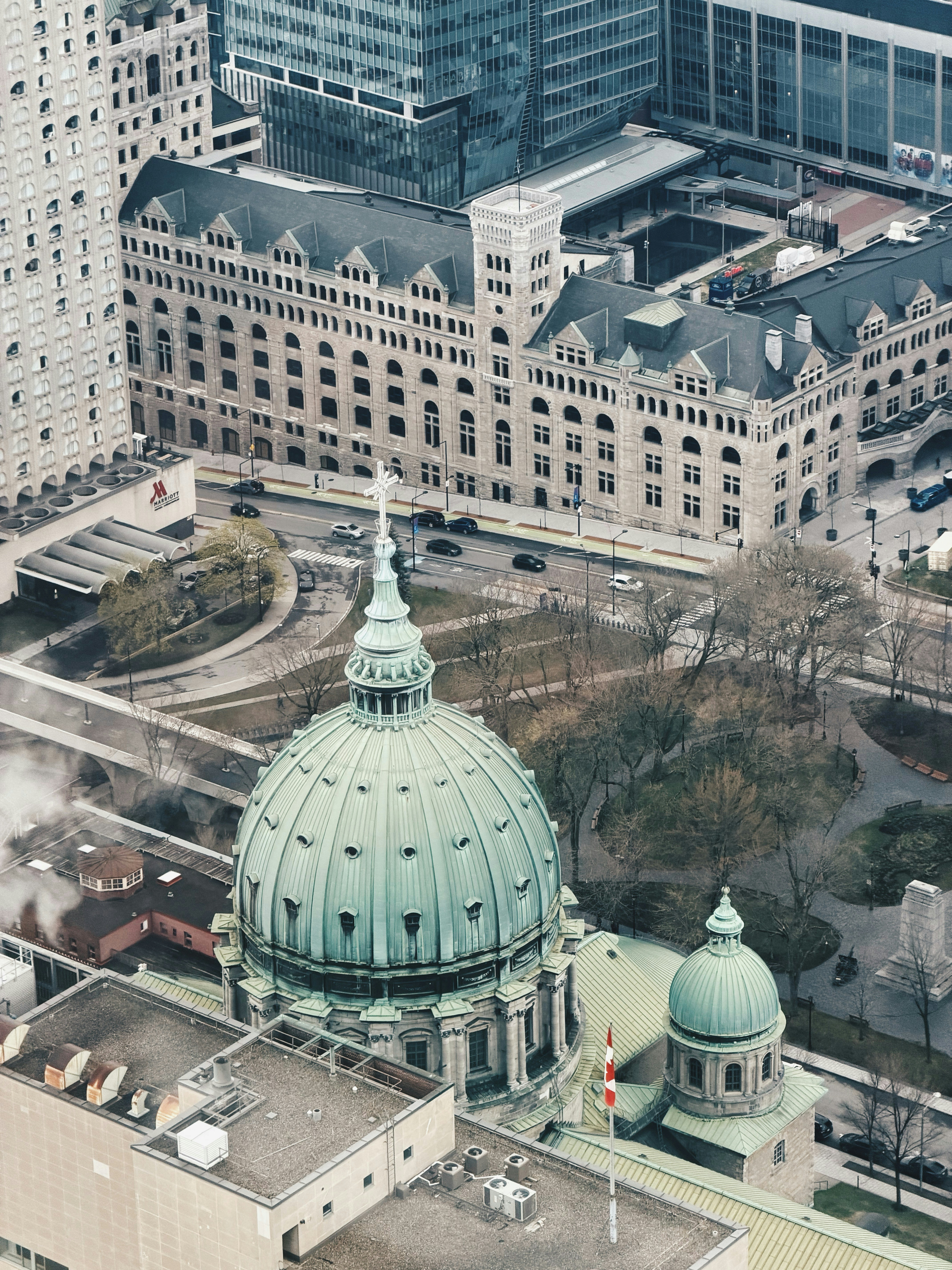 Green dome building surrounded by city architecture