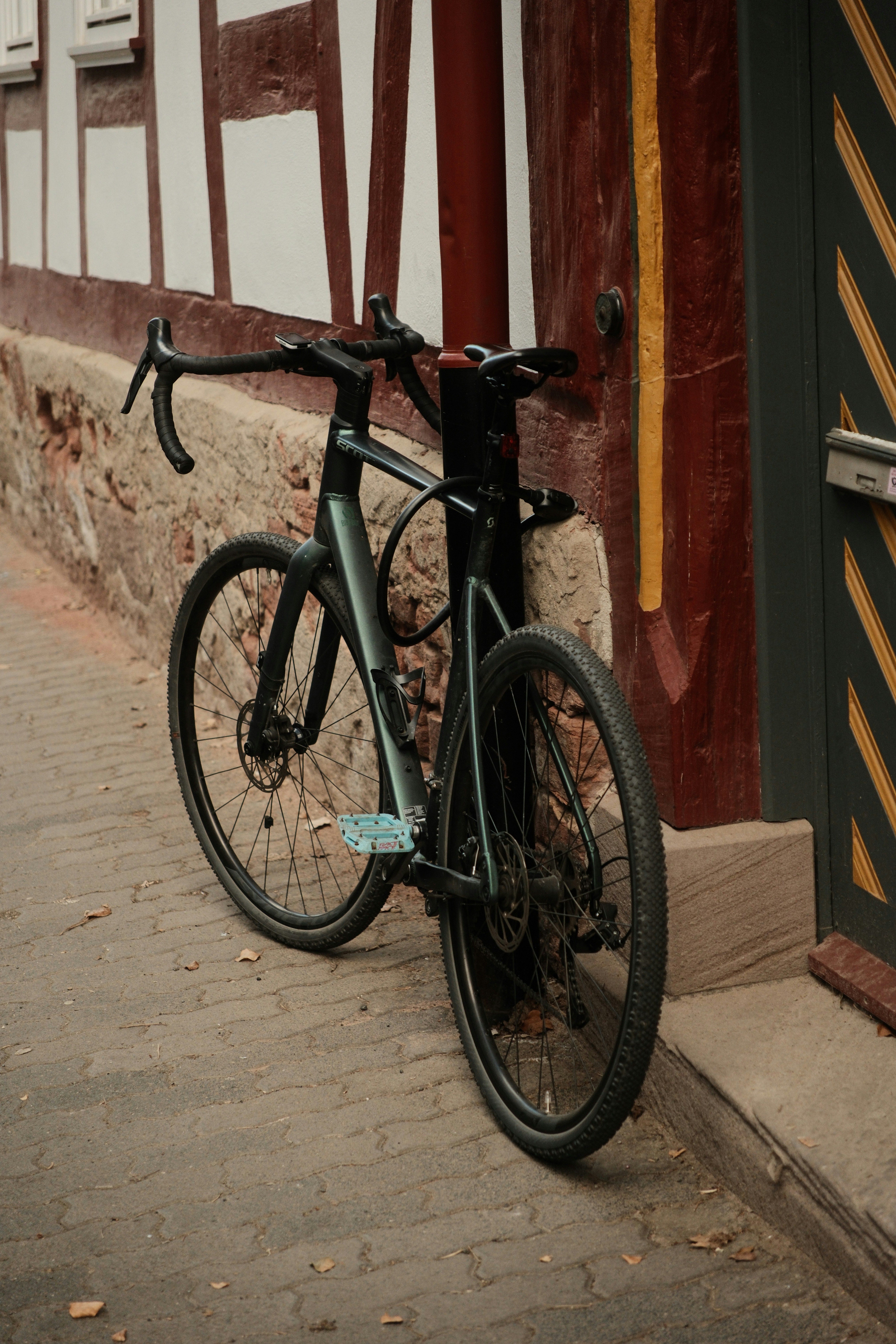 A bicycle leans against a building wall.