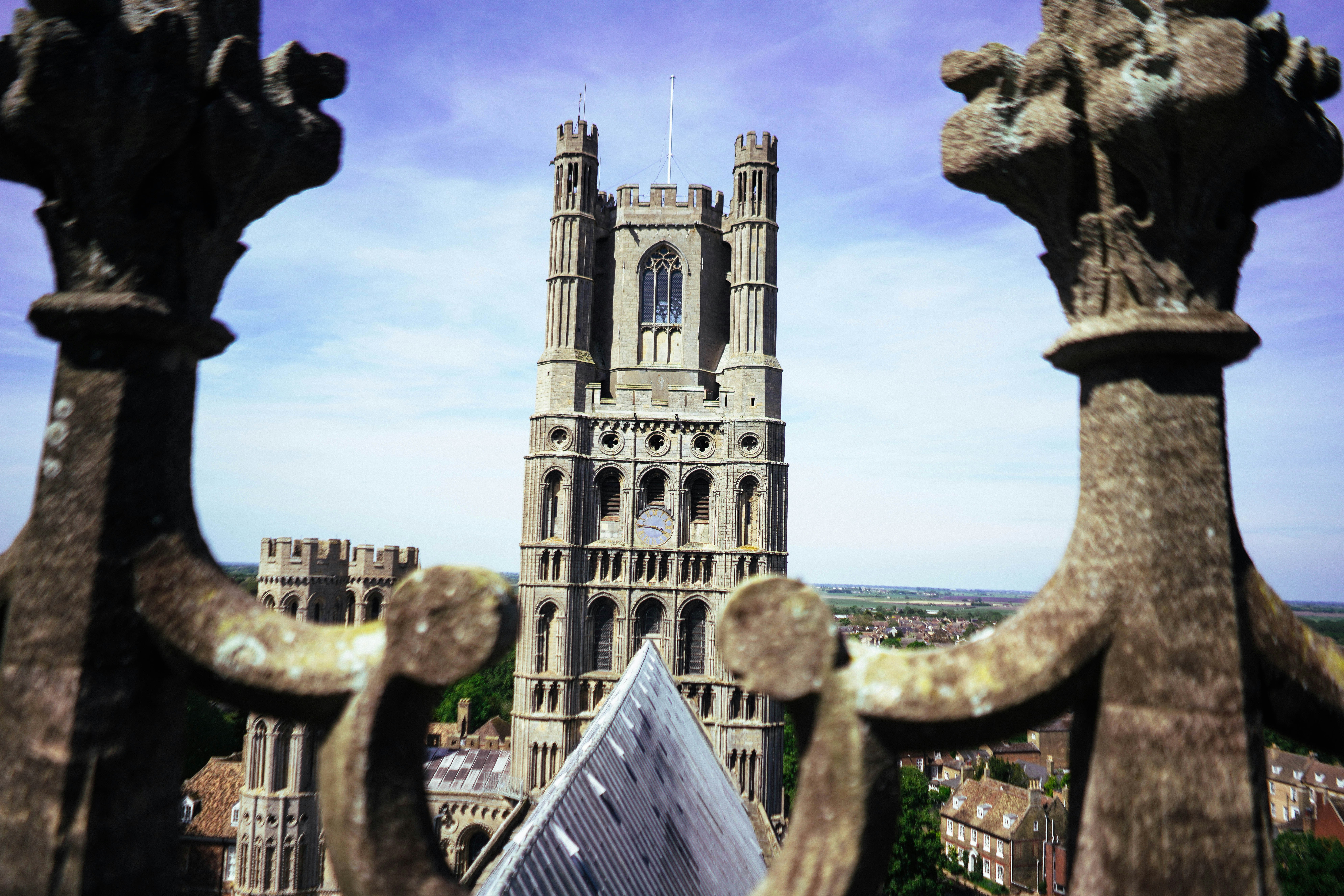 Tall cathedral tower framed by ornate stone carvings