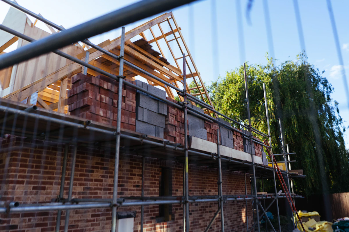 Brick house under construction with scaffolding