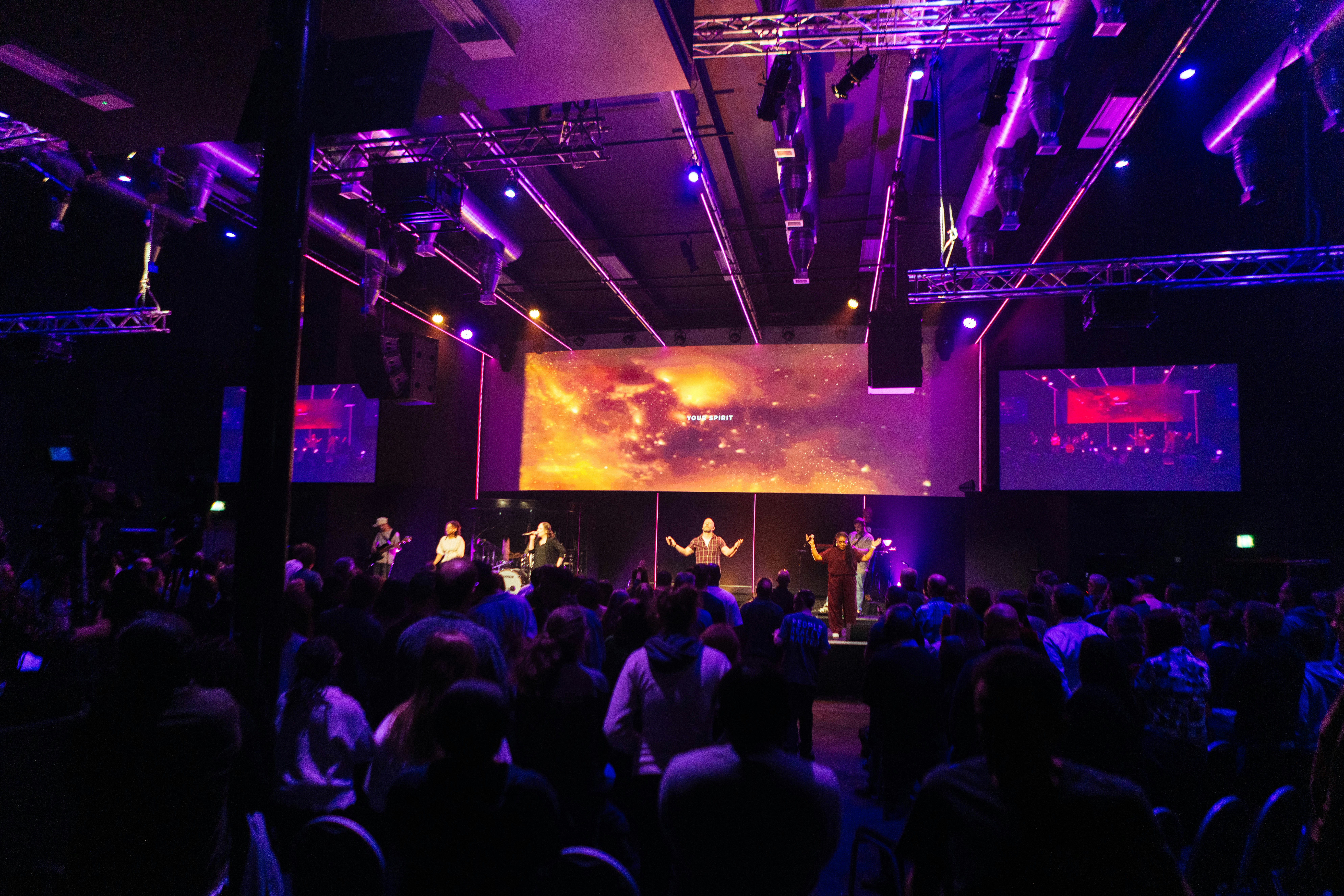 People gathered in a large hall for a presentation