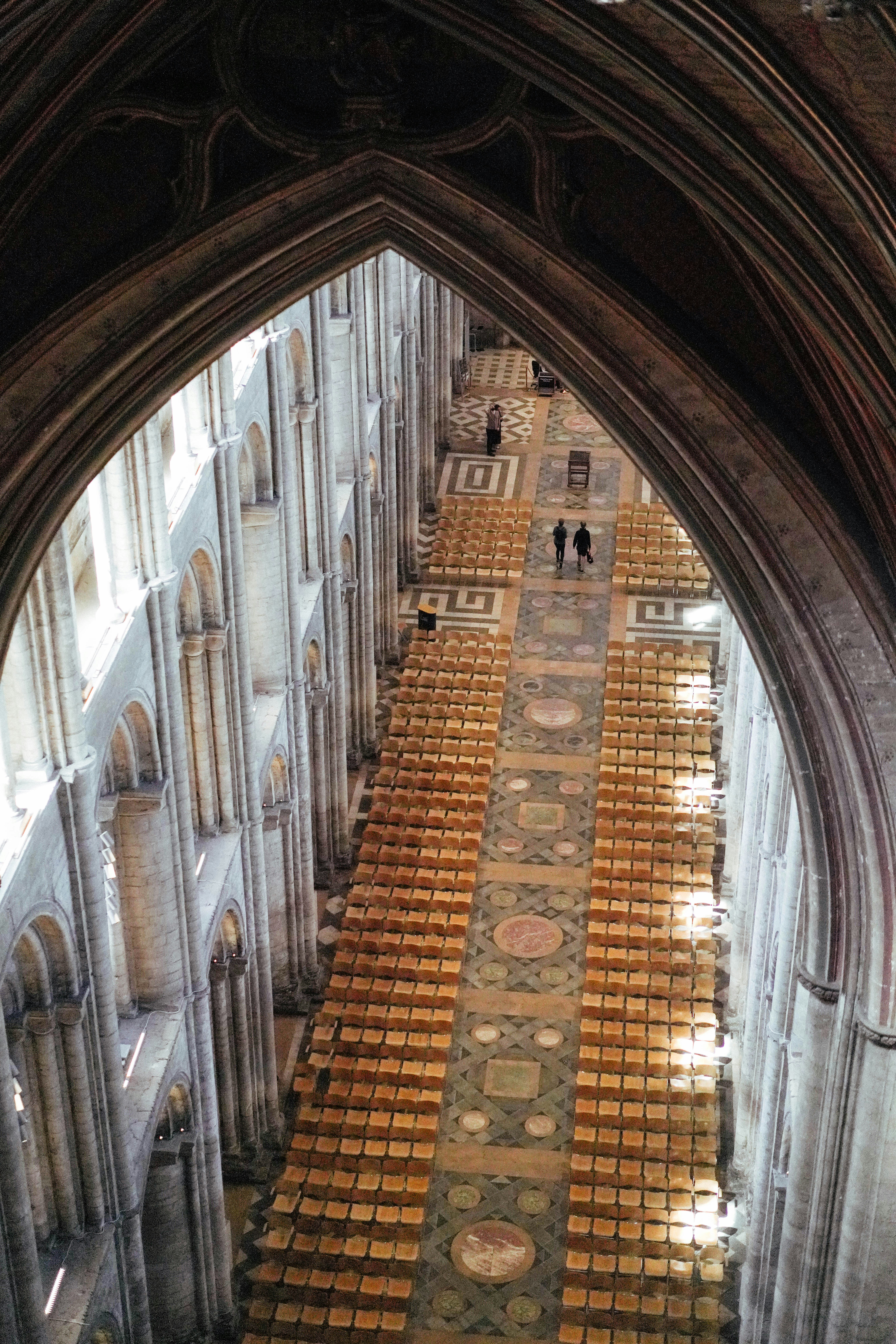 View down a cathedral nave with rows of empty seats.