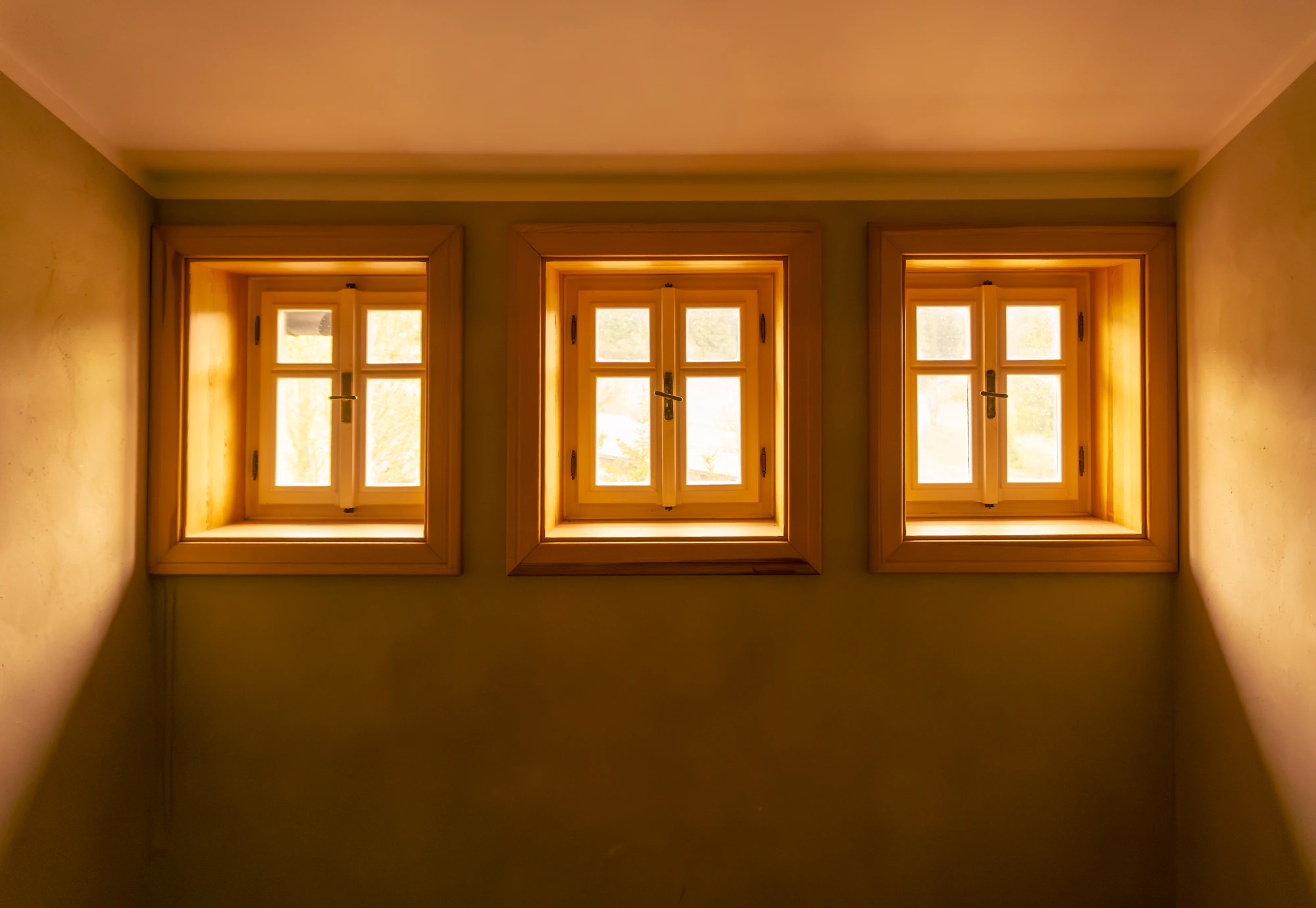 Wood-framed windows with warm light