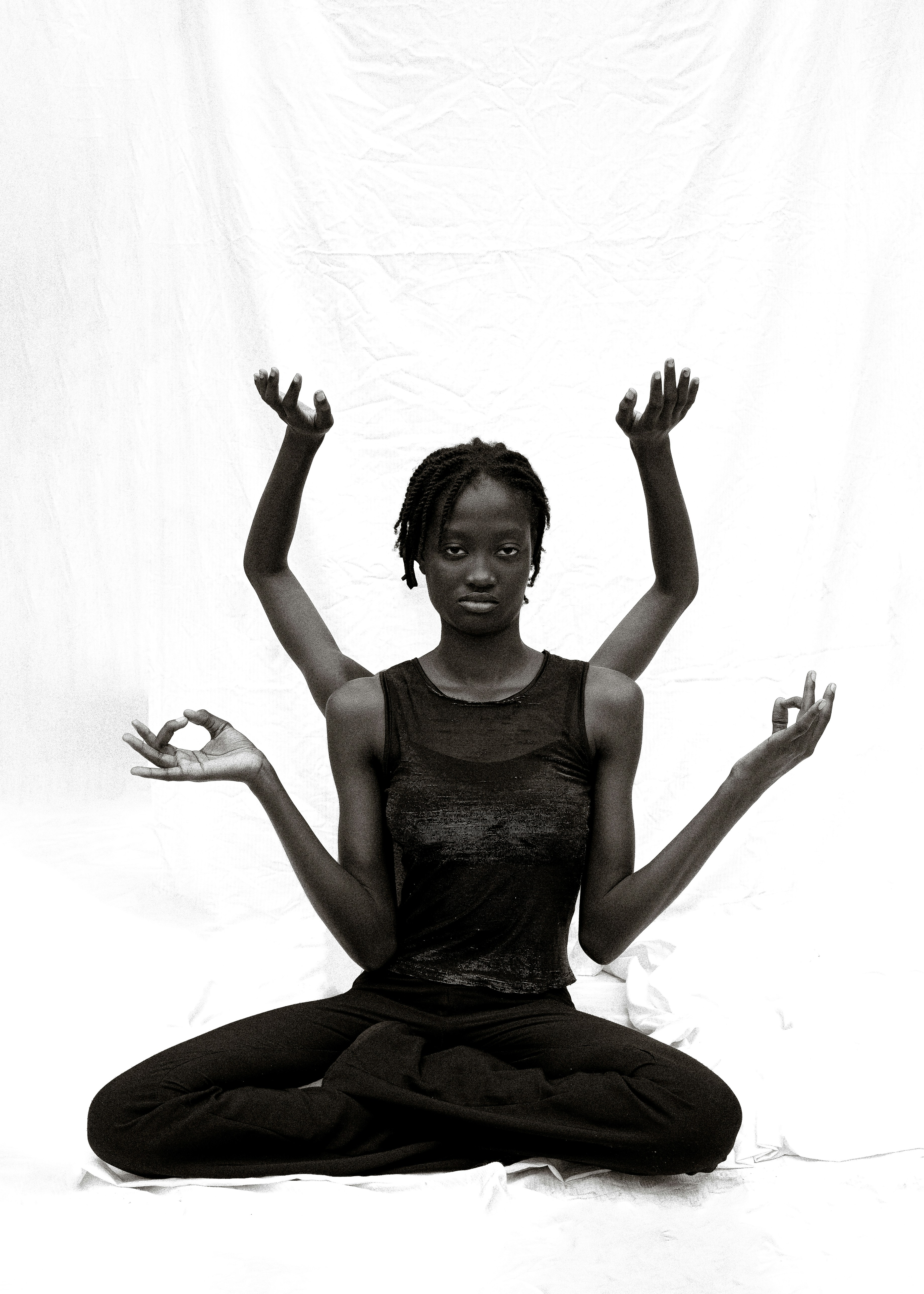 Woman in yoga pose with multiple arms
