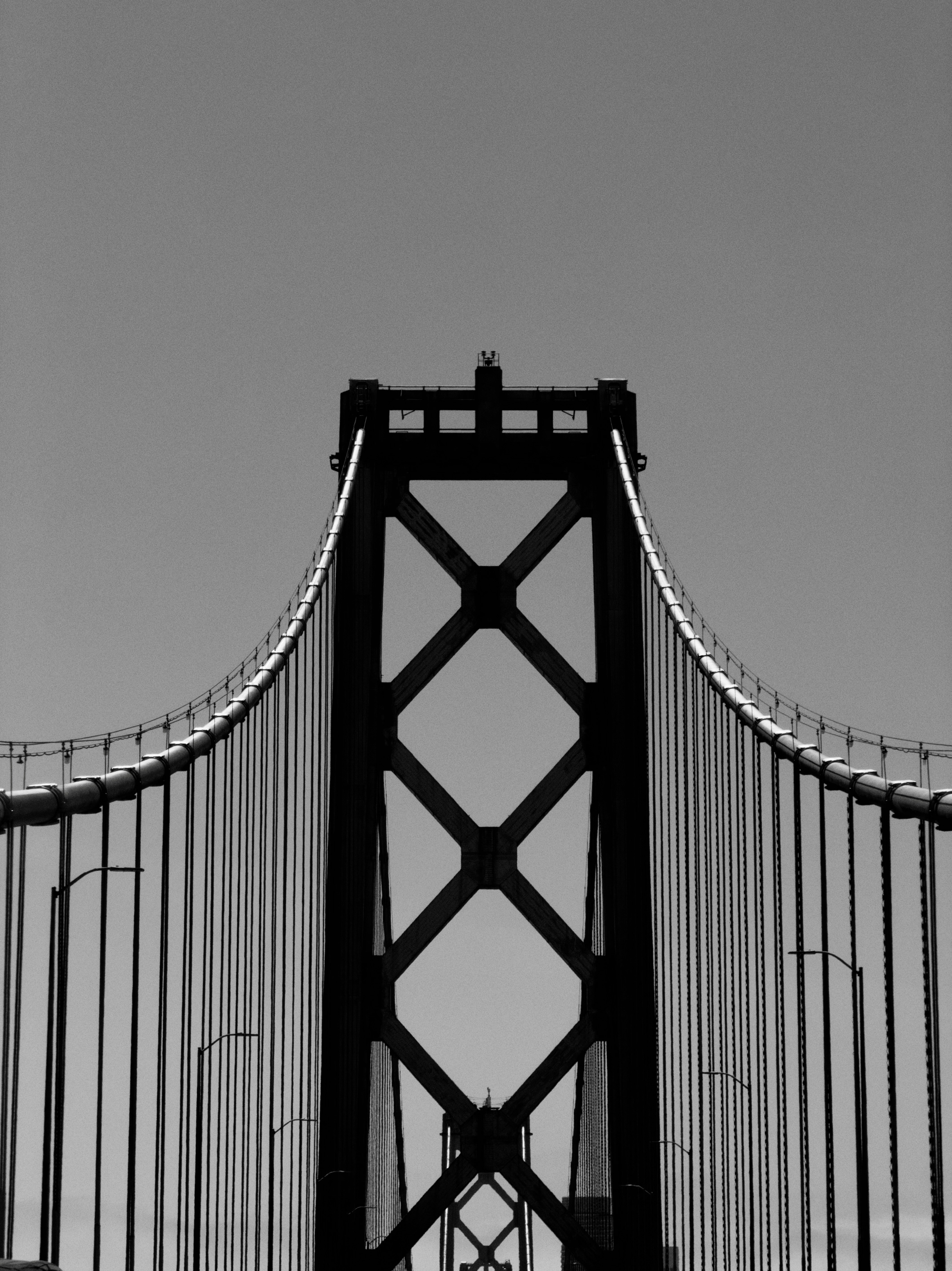 Close-up of a suspension bridge tower against clear sky