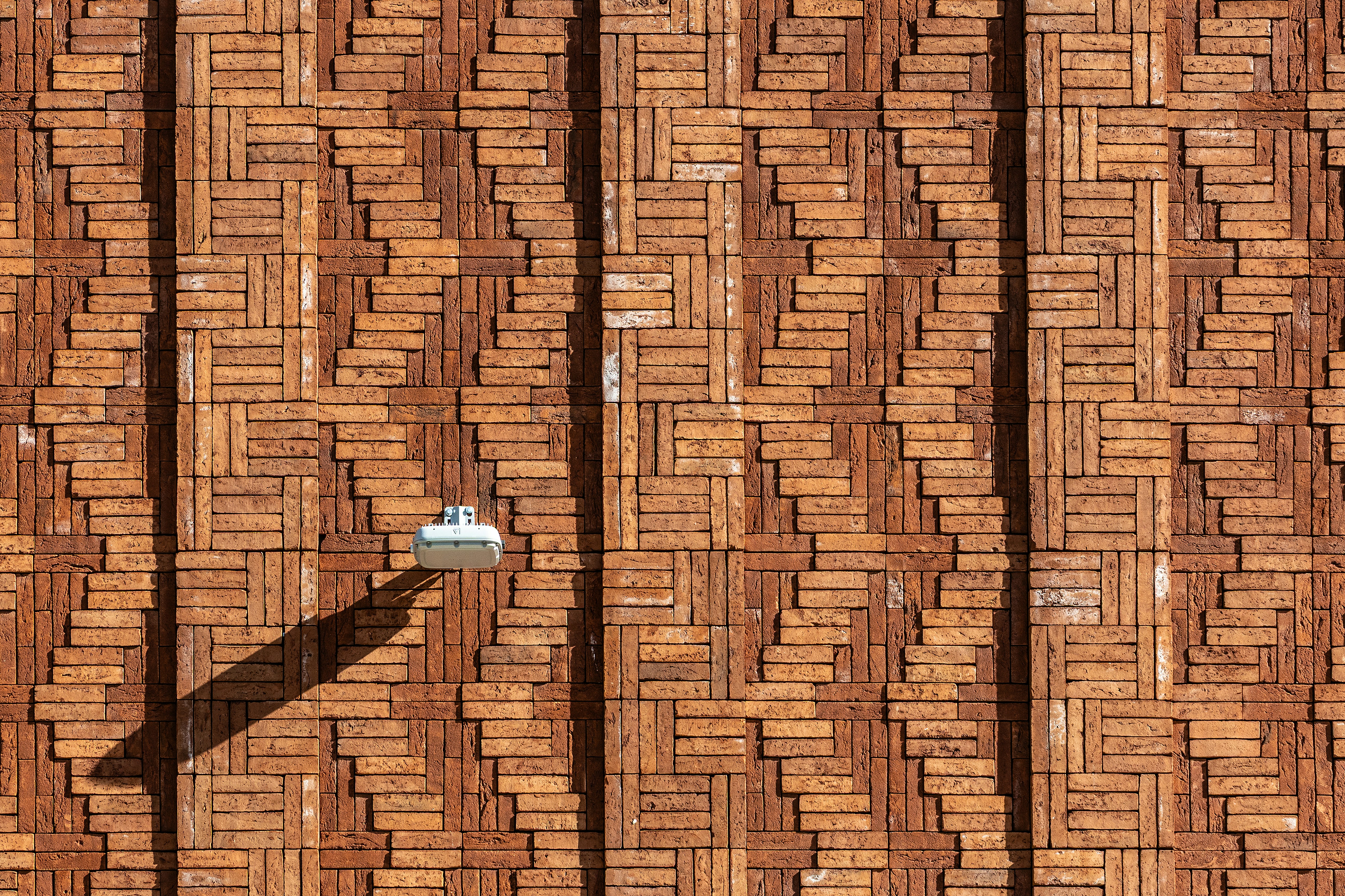 Textured brick wall with a security camera