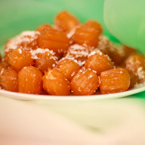 Plate of sweet, syrupy, fried dough balls