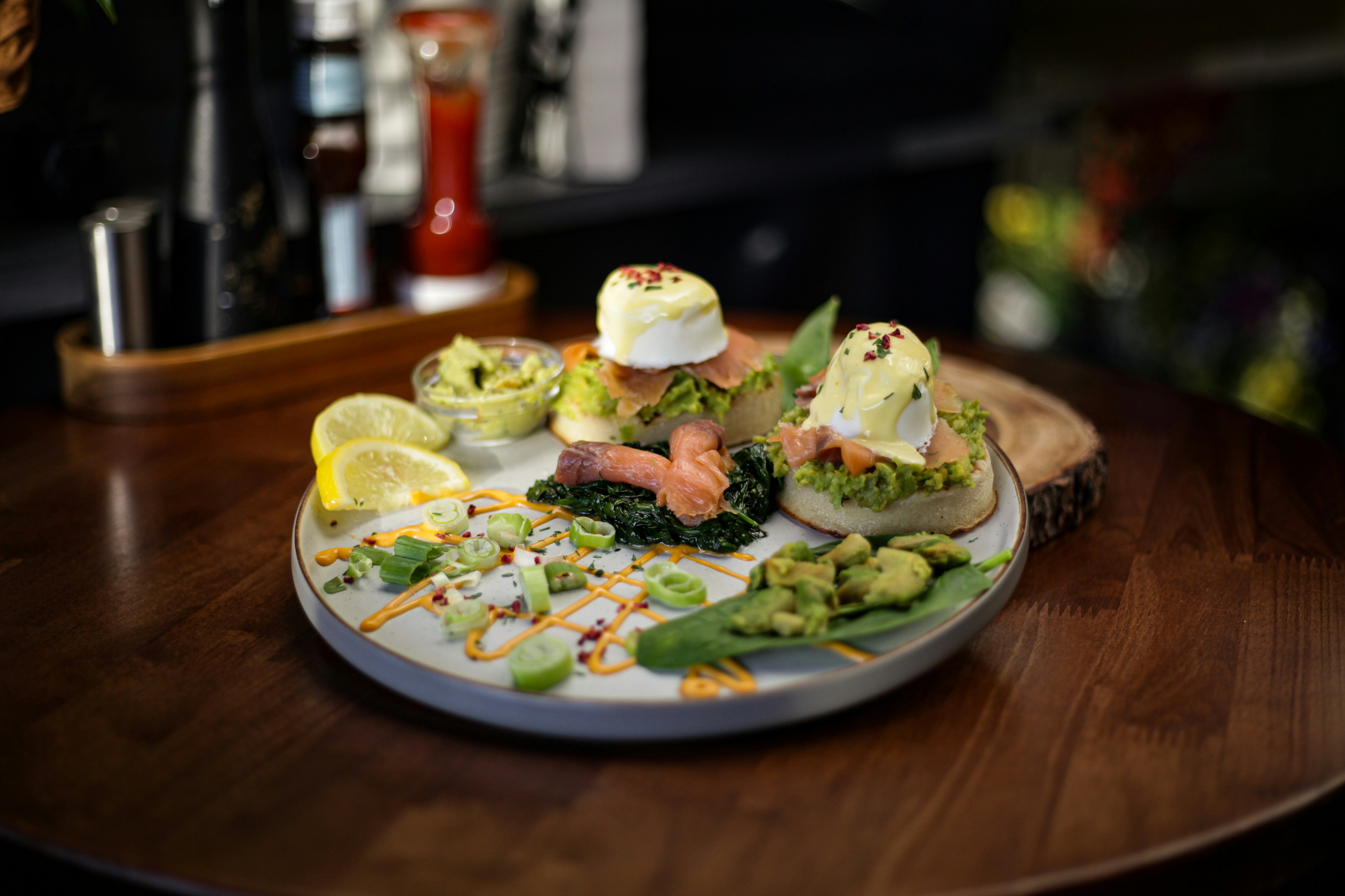 Gourmet breakfast plate with salmon, avocado, and poached eggs.