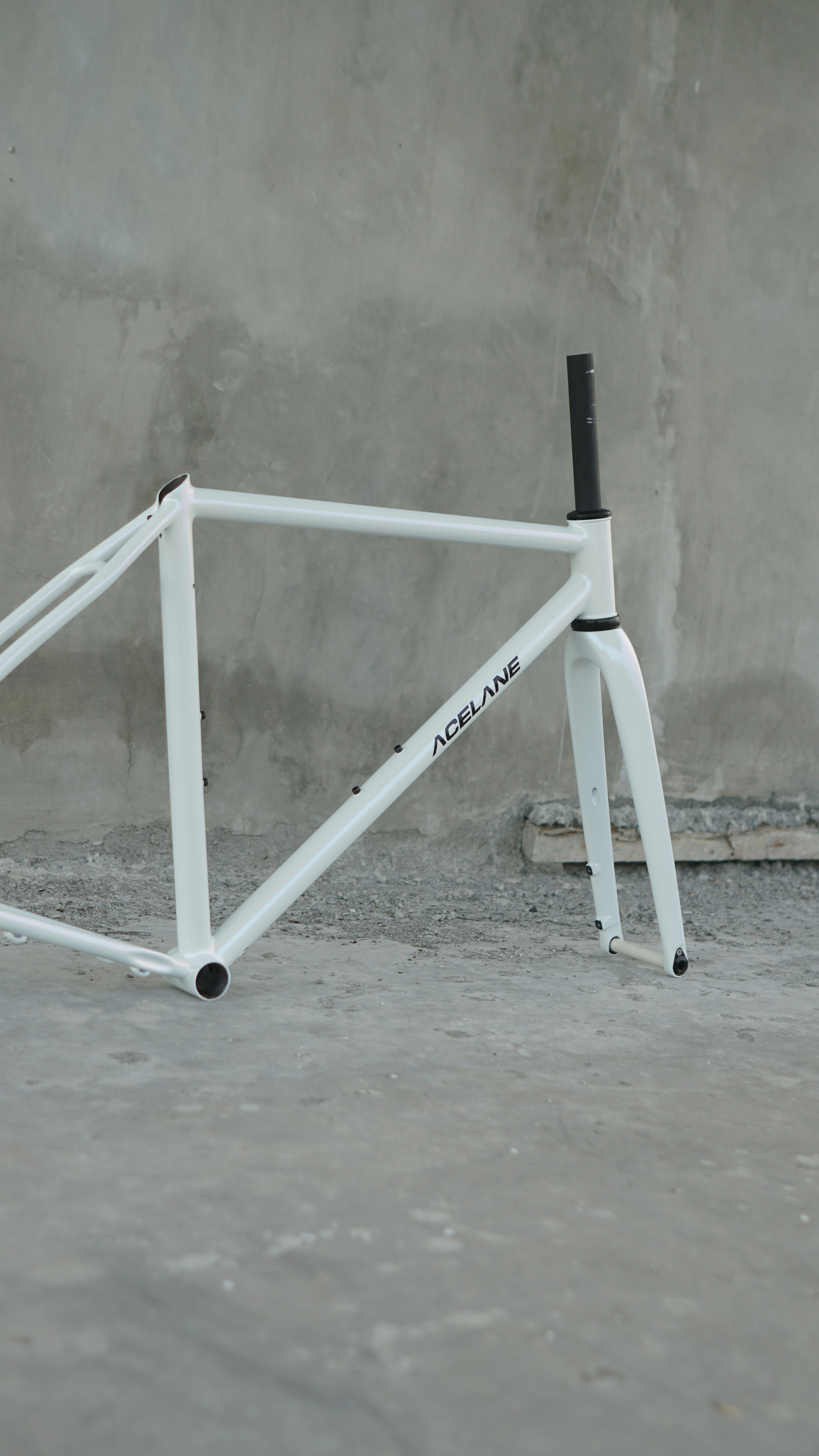 White bicycle frame with acelane logo on the side