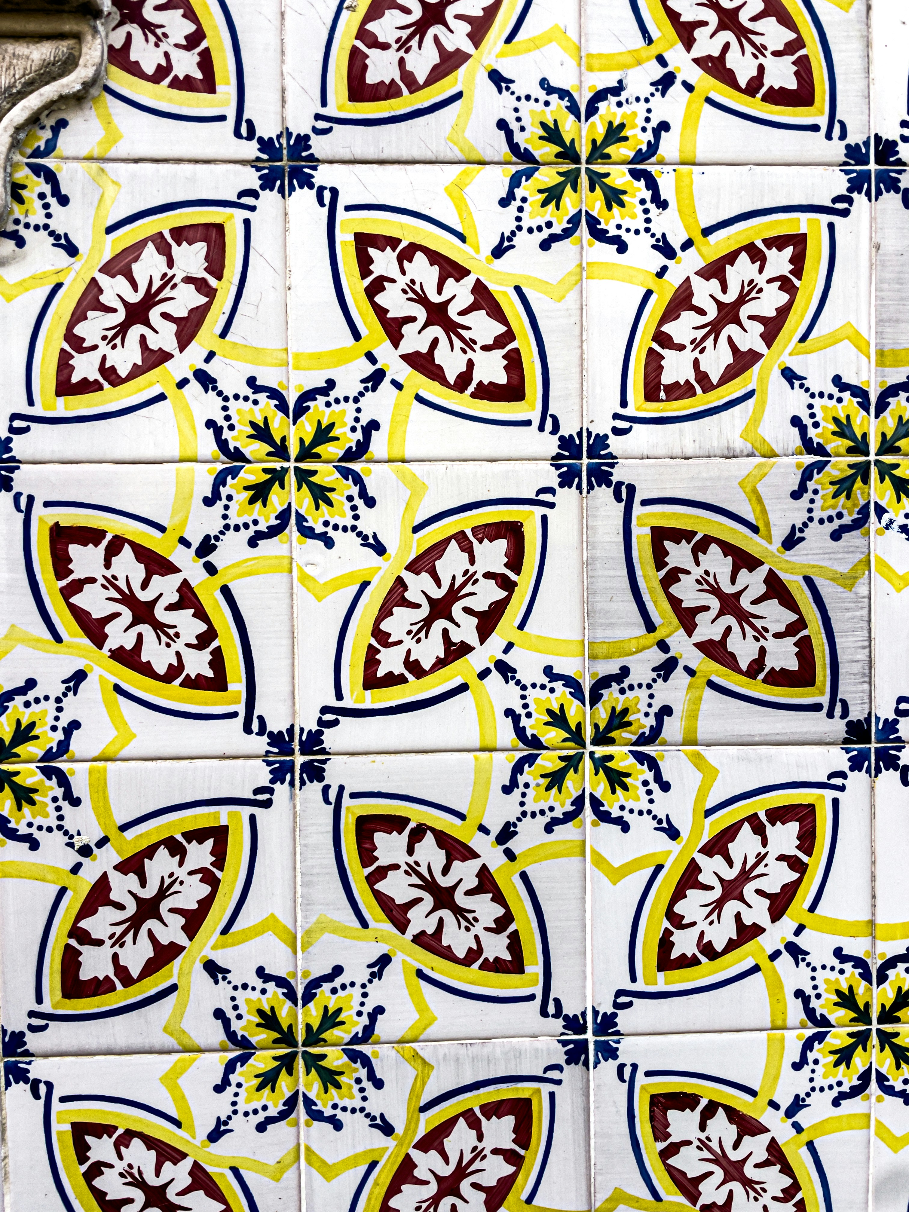 White tiles with yellow and maroon floral patterns