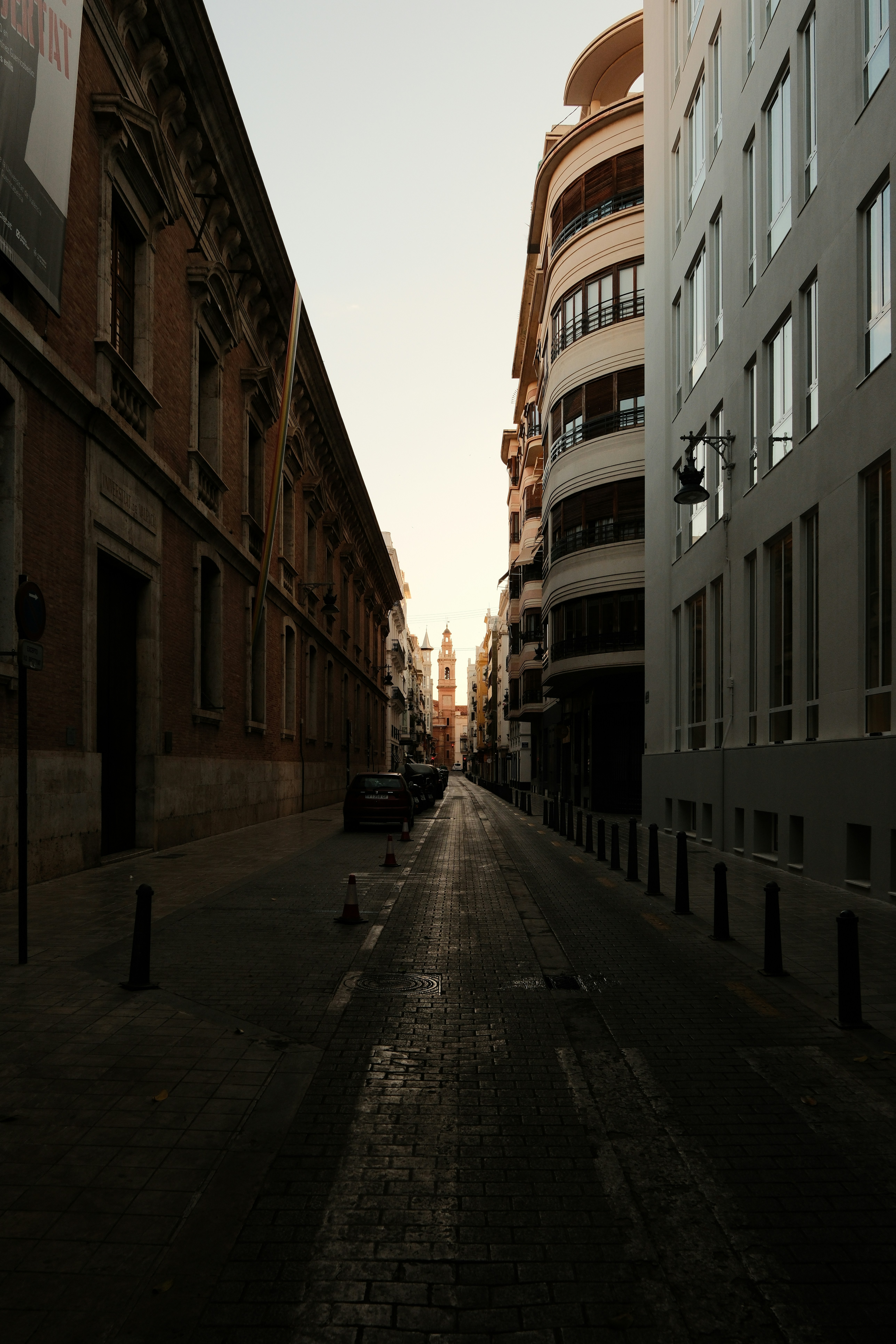 Photo of Empty street with buildings at dawn by Claudio Schwarz