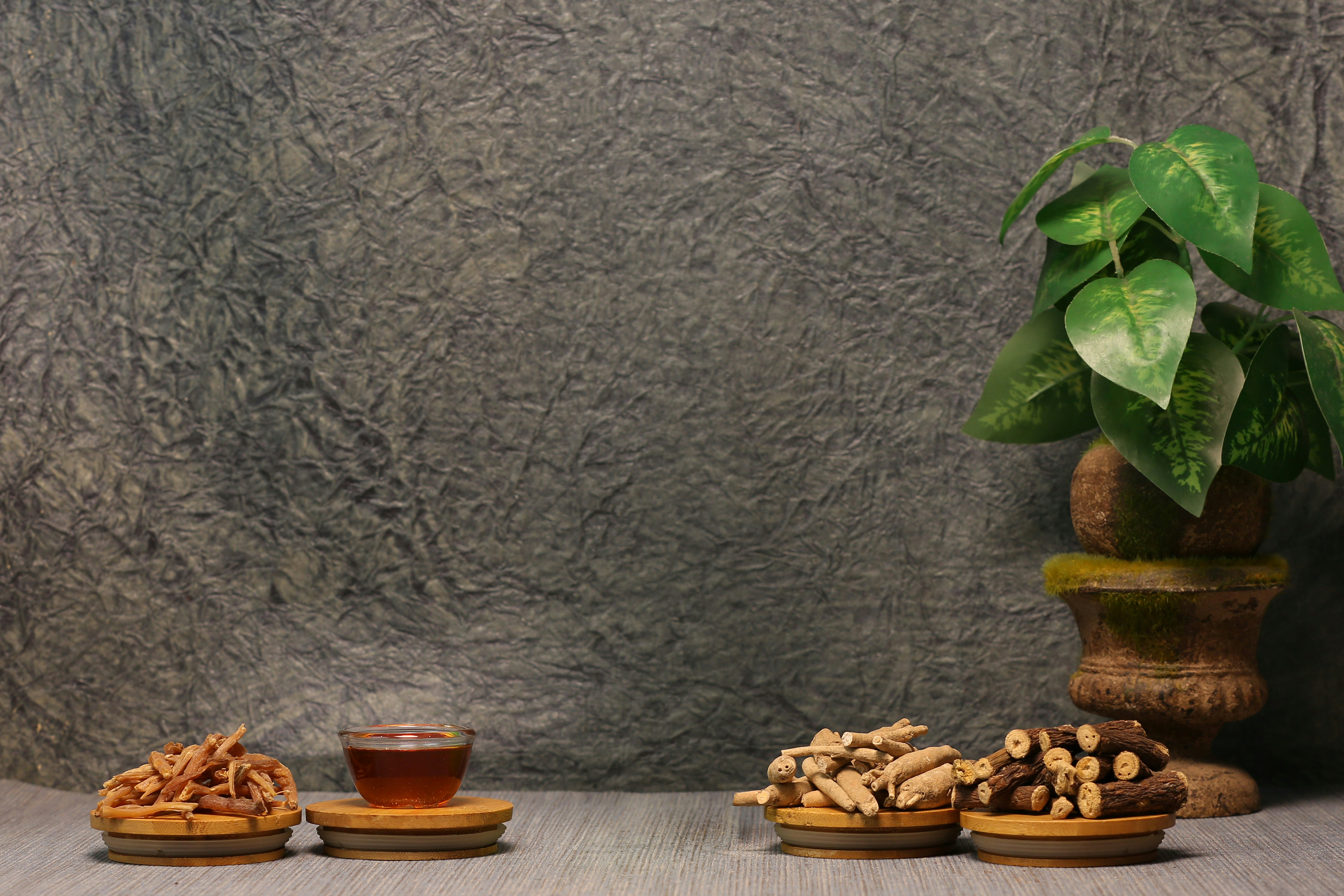 Three wooden bowls of snacks and a cup of tea.