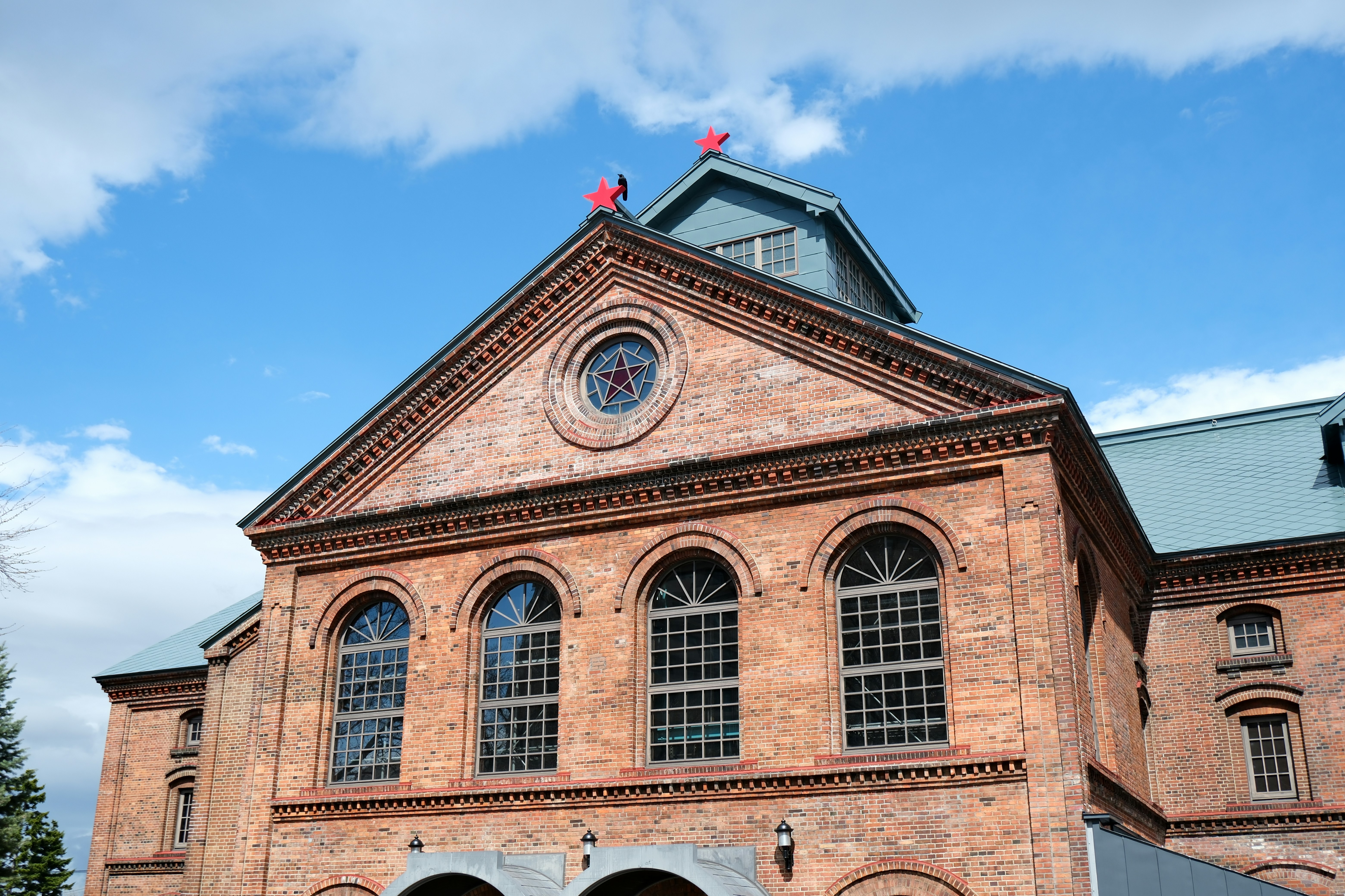 Old brick building with arched windows under blue sky