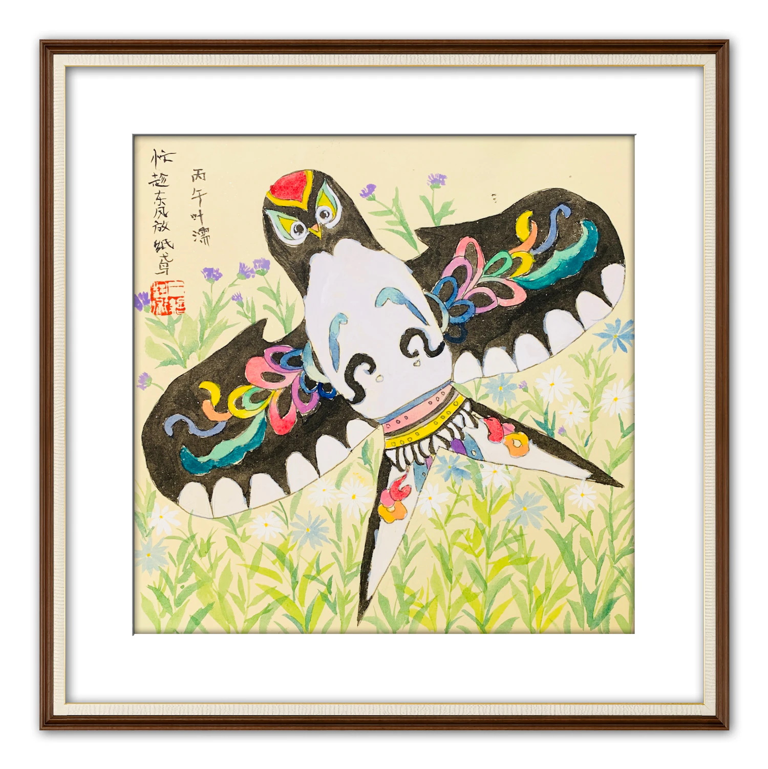 A painted swallow kite in red, black and yellow, framed on a white wall