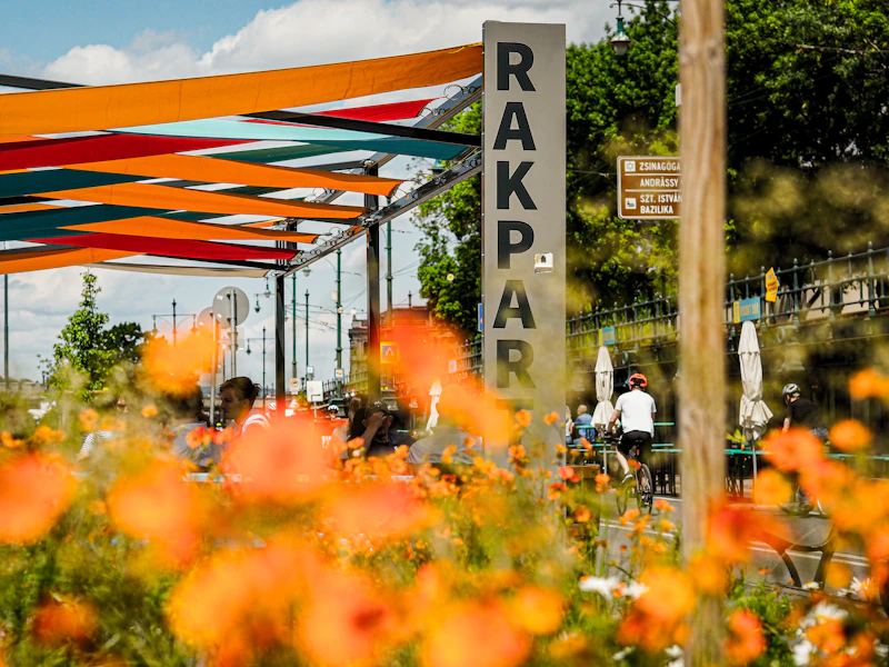 Cafe sign with orange flowers and patrons