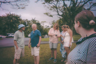 Group of people gathered outdoors near trees