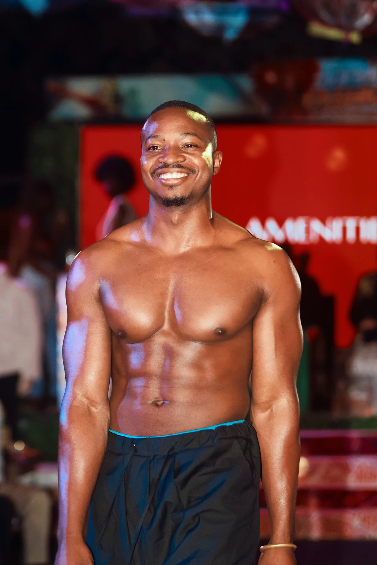 Ripped young Black man showing six pack - male vitality and stamina
