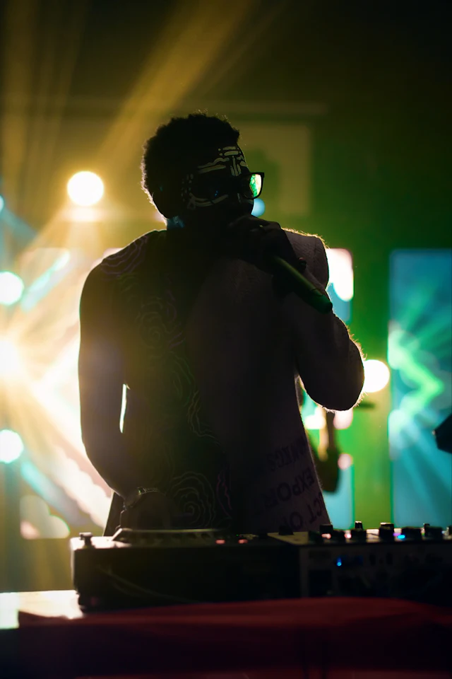 A DJ playing under bright lights