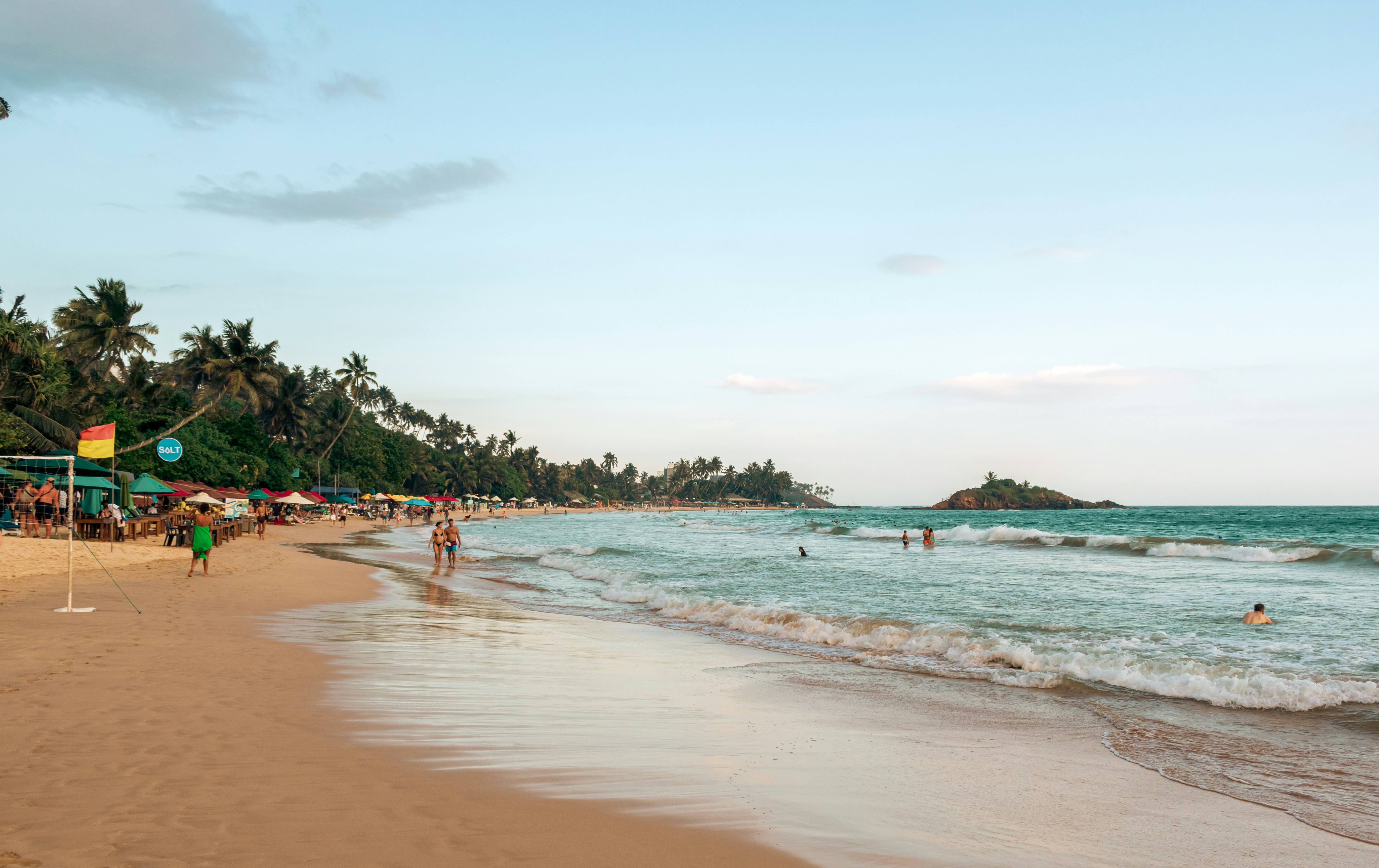 People enjoying a sunny day at a tropical beach