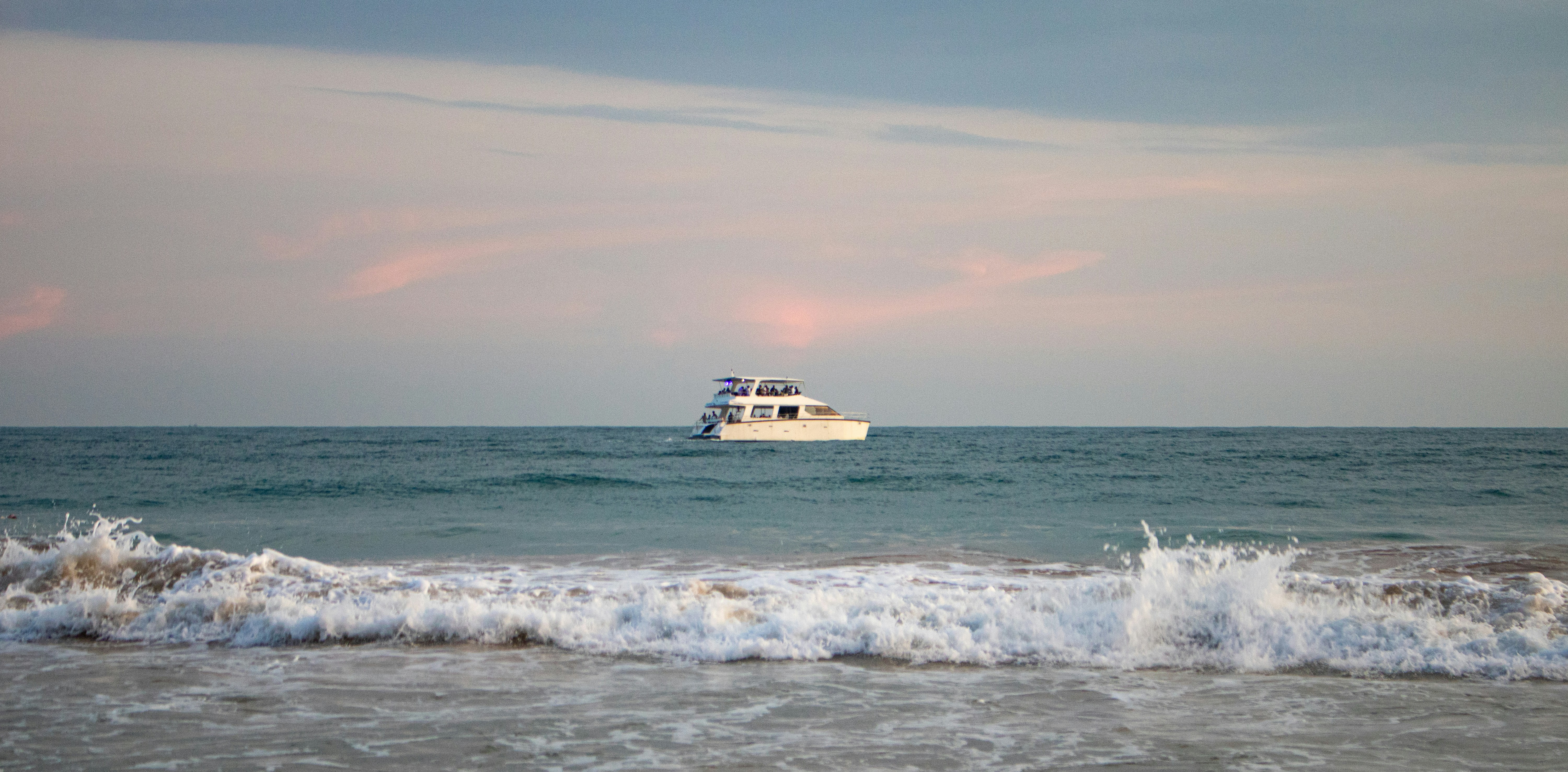 Yacht sailing on the ocean at sunset