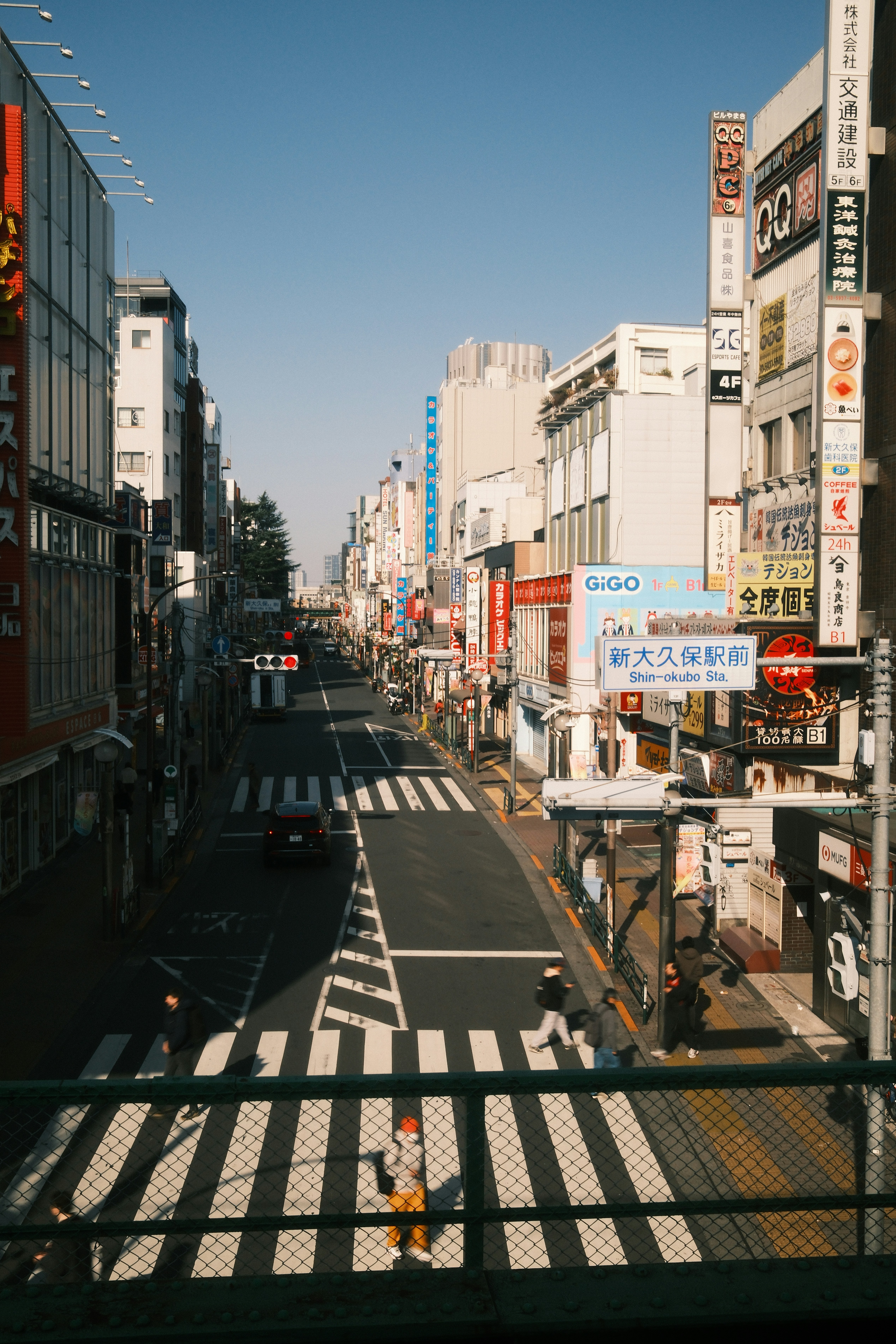 A busy street in a japanese city with many signs.