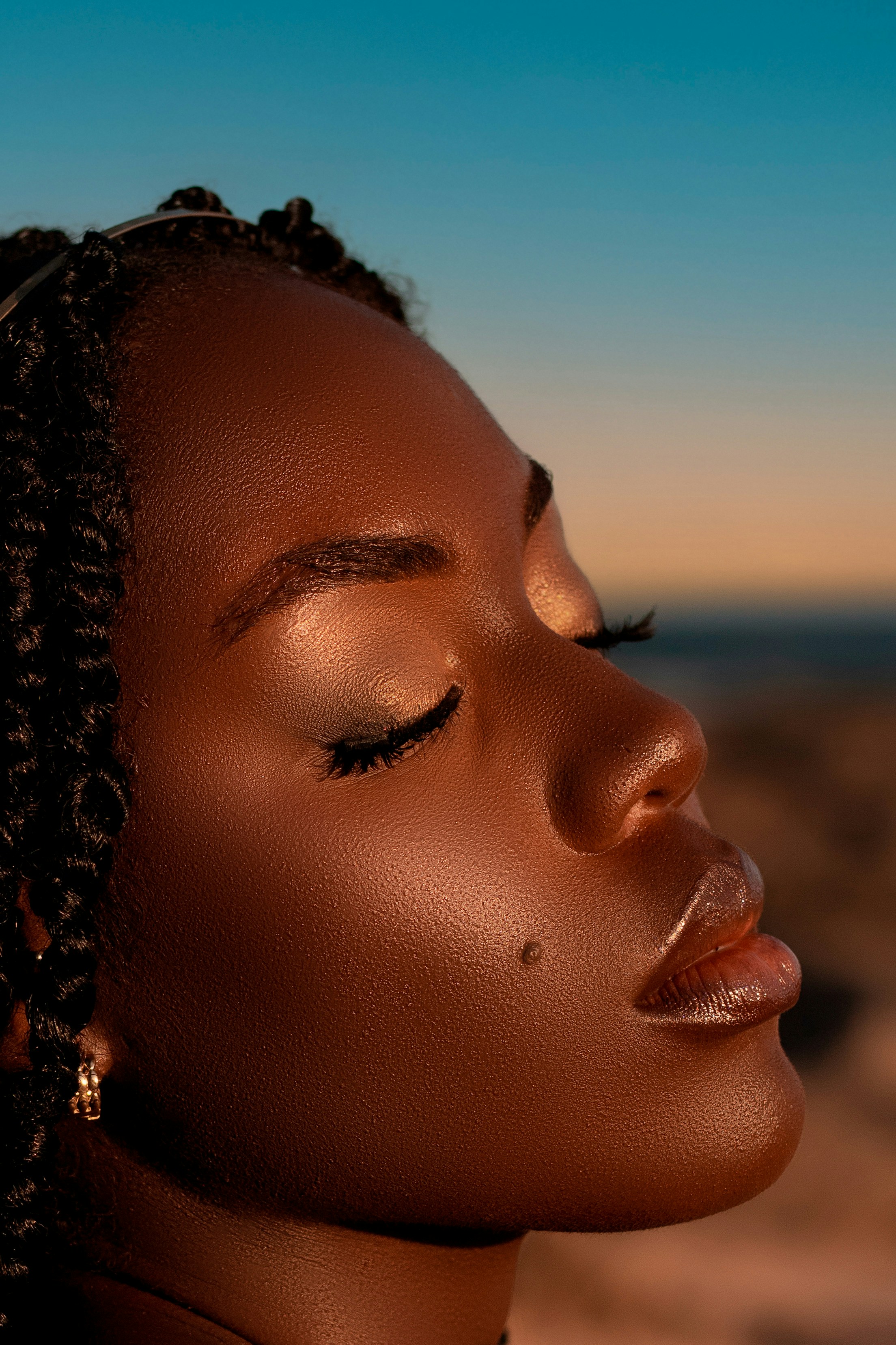 Close-up profile of a woman with eyes closed.