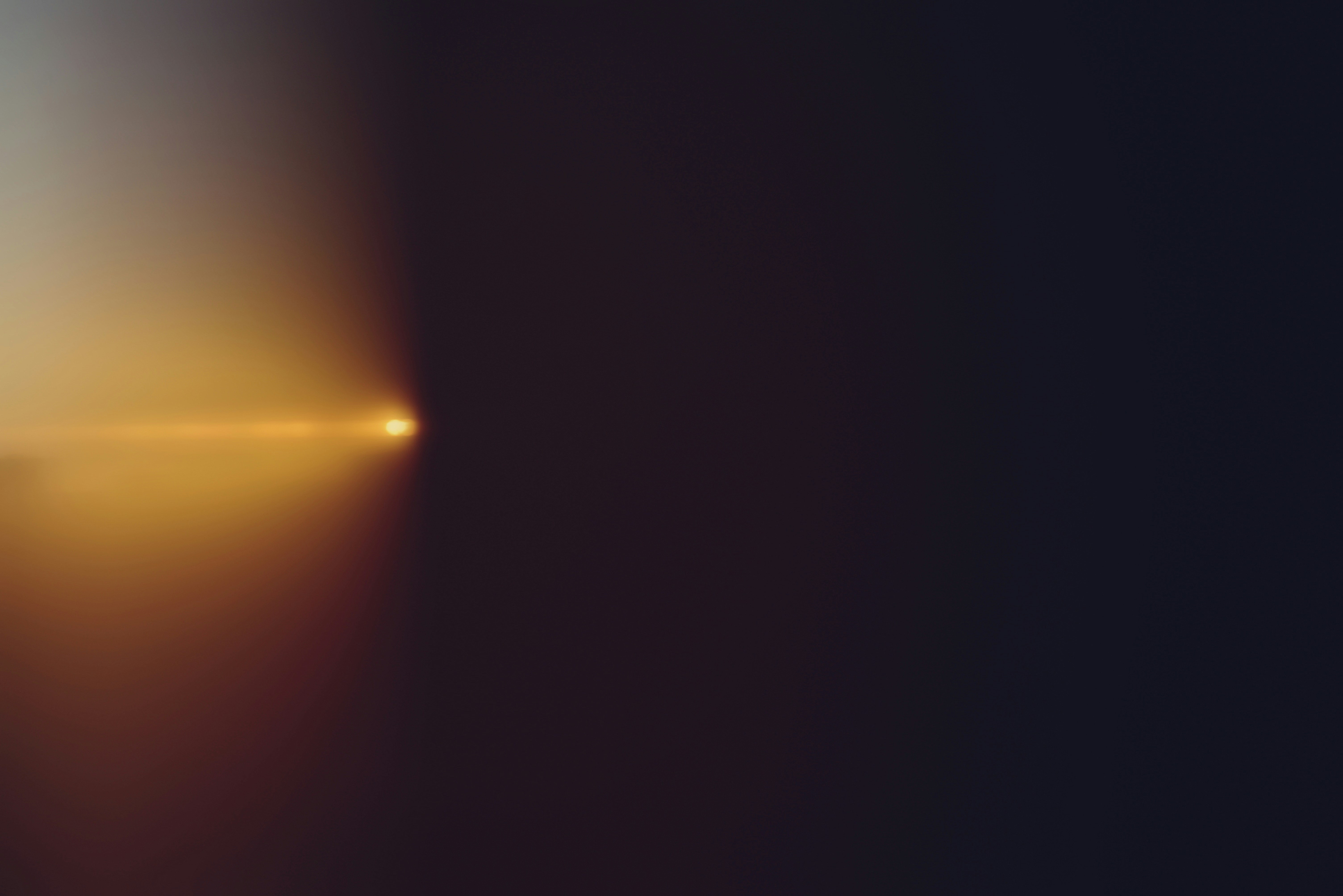 Un raggio di luce intenso illumina uno sfondo scuro