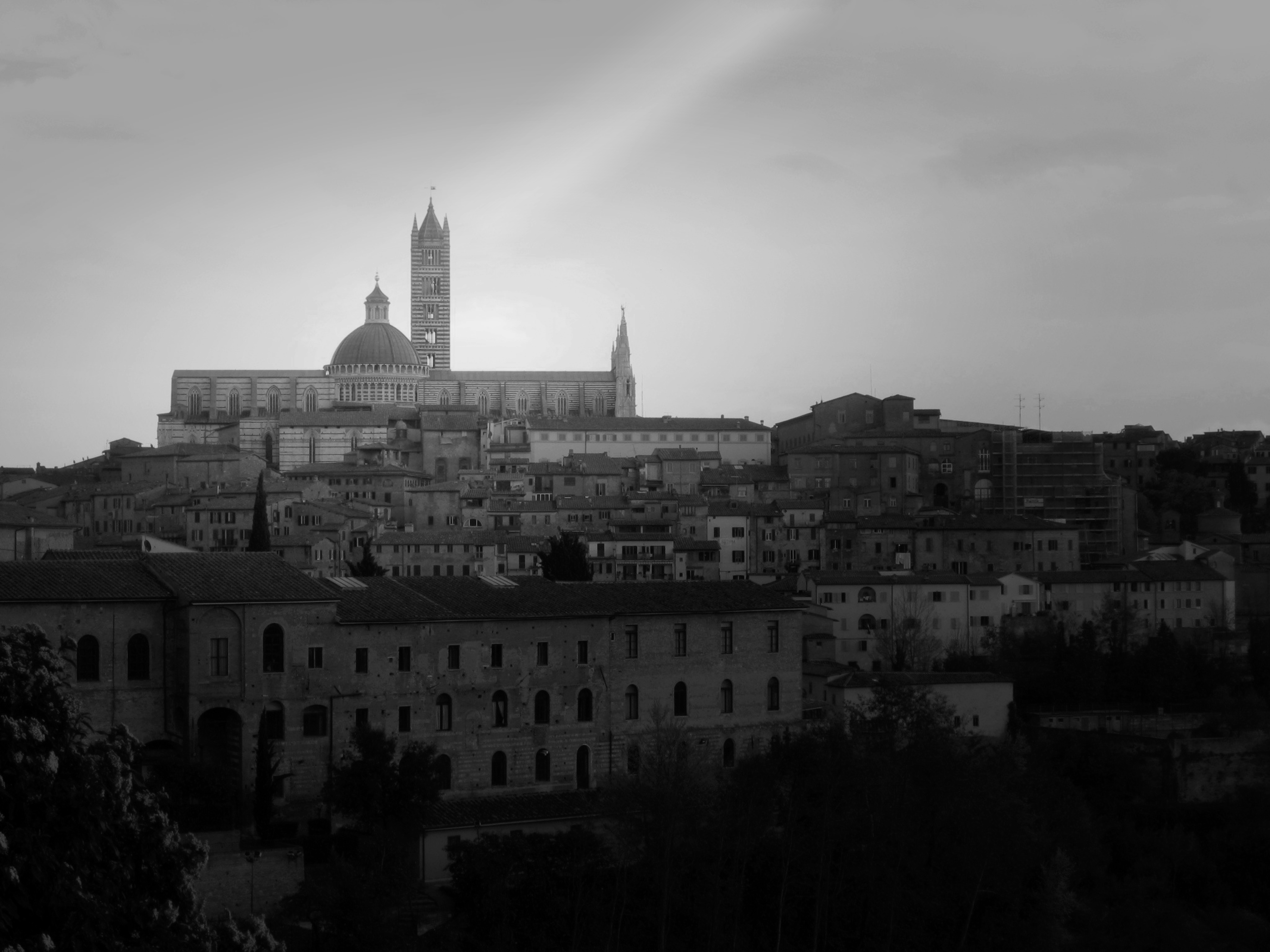 Historic cityscape with a large cathedral and dome.