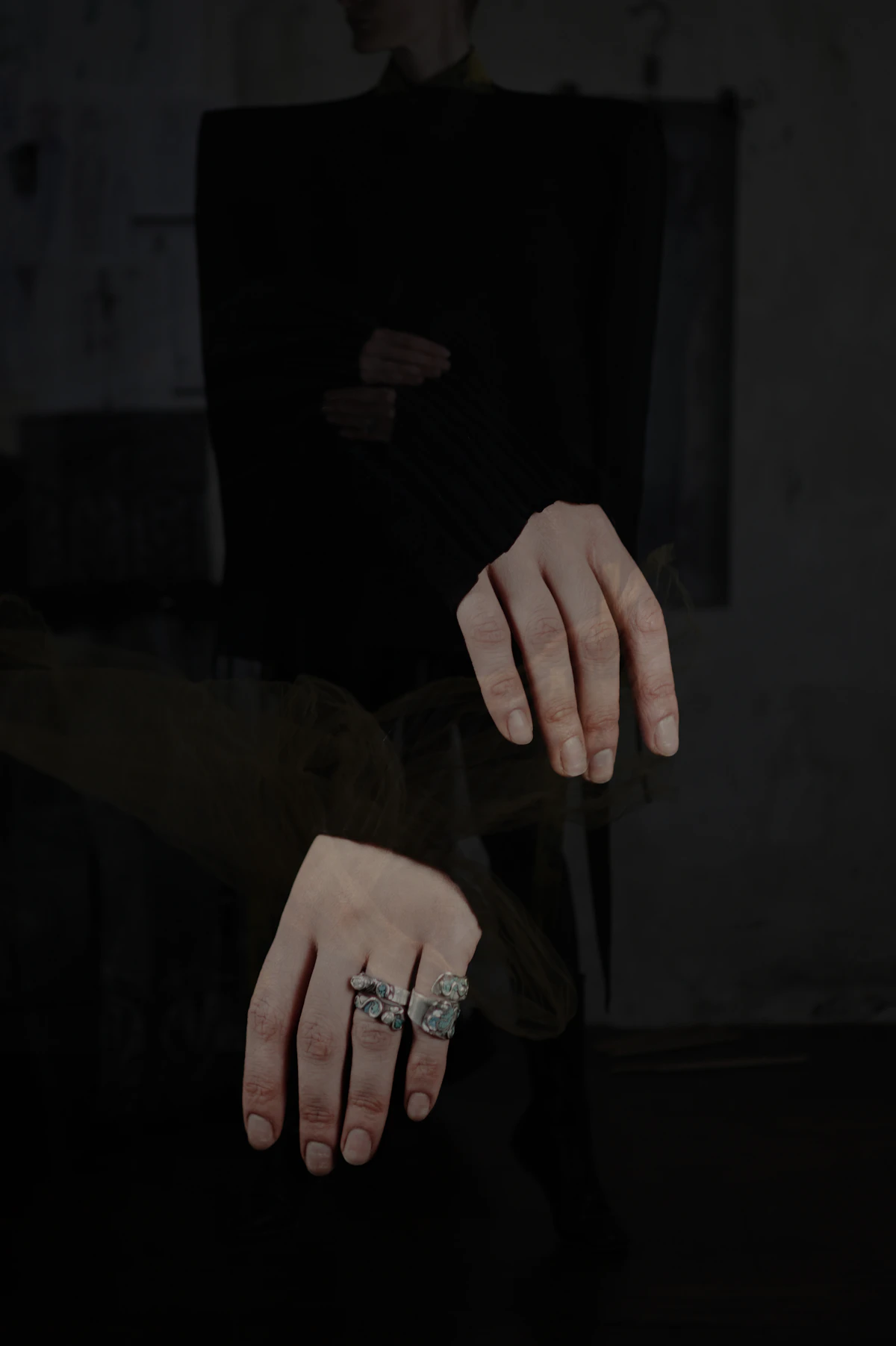 A hand adorned with gold rings set with sparkling gemstones