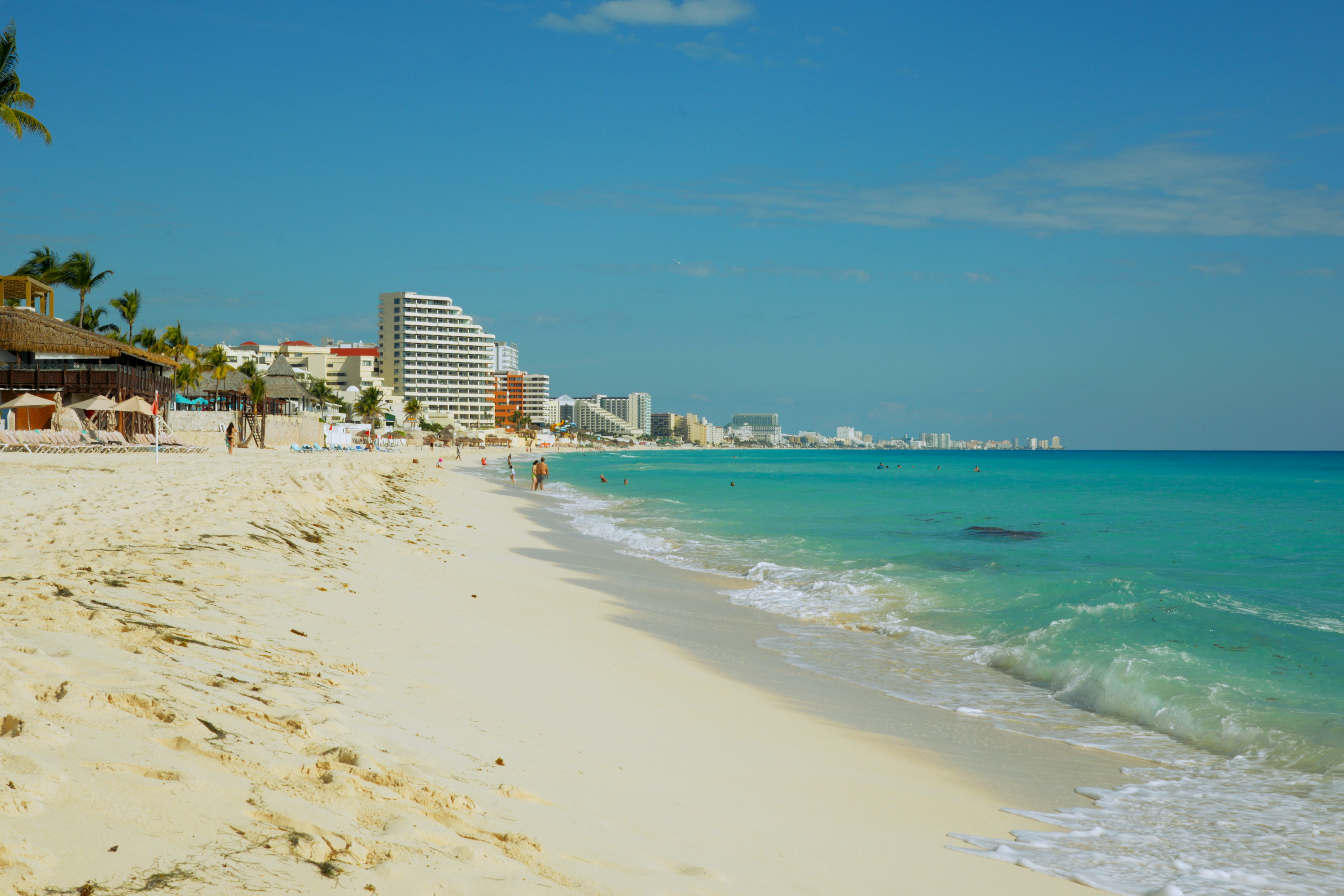 A tropical beach with white sand and turquoise water.