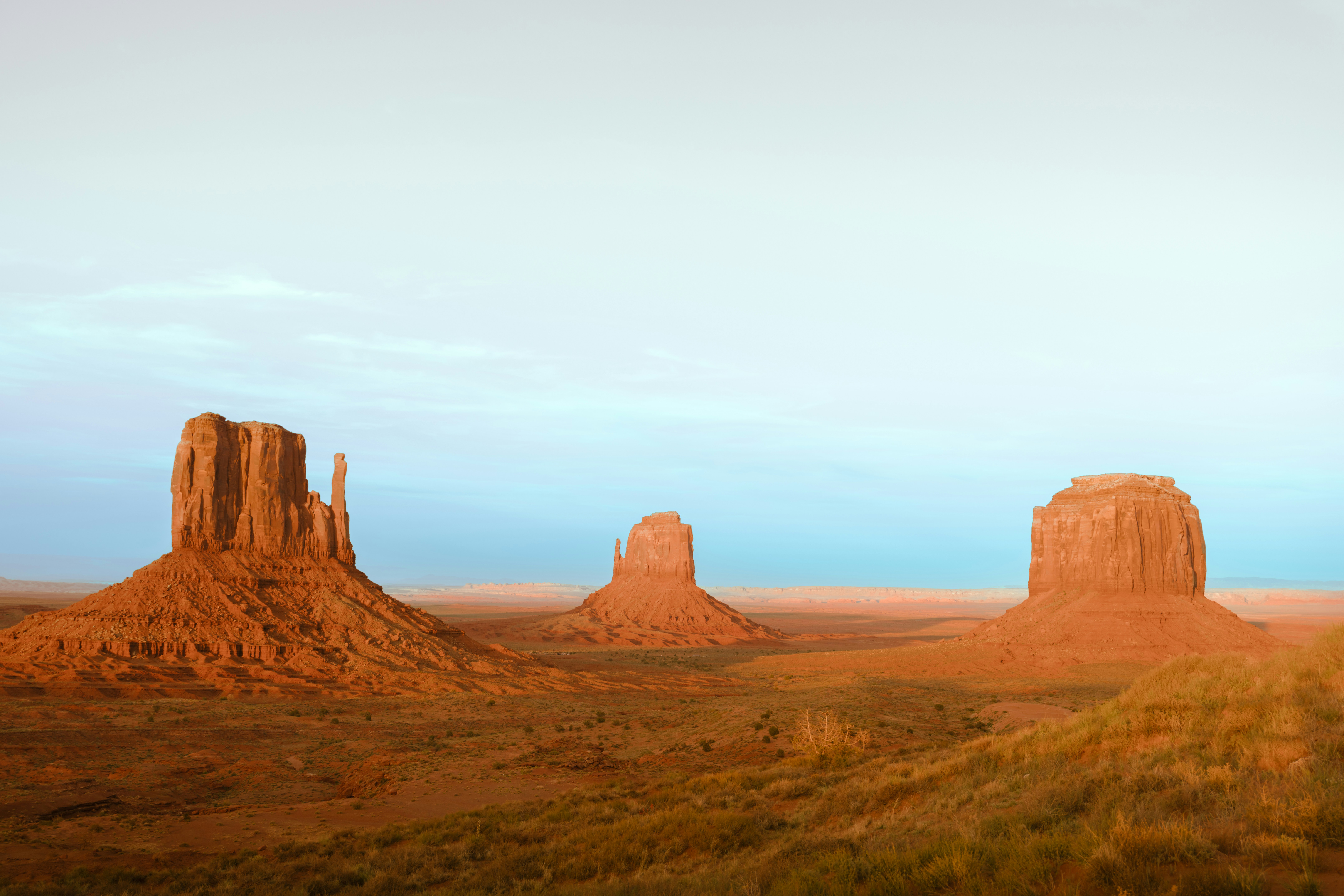 Three sandstone buttes in monument valley desert landscape