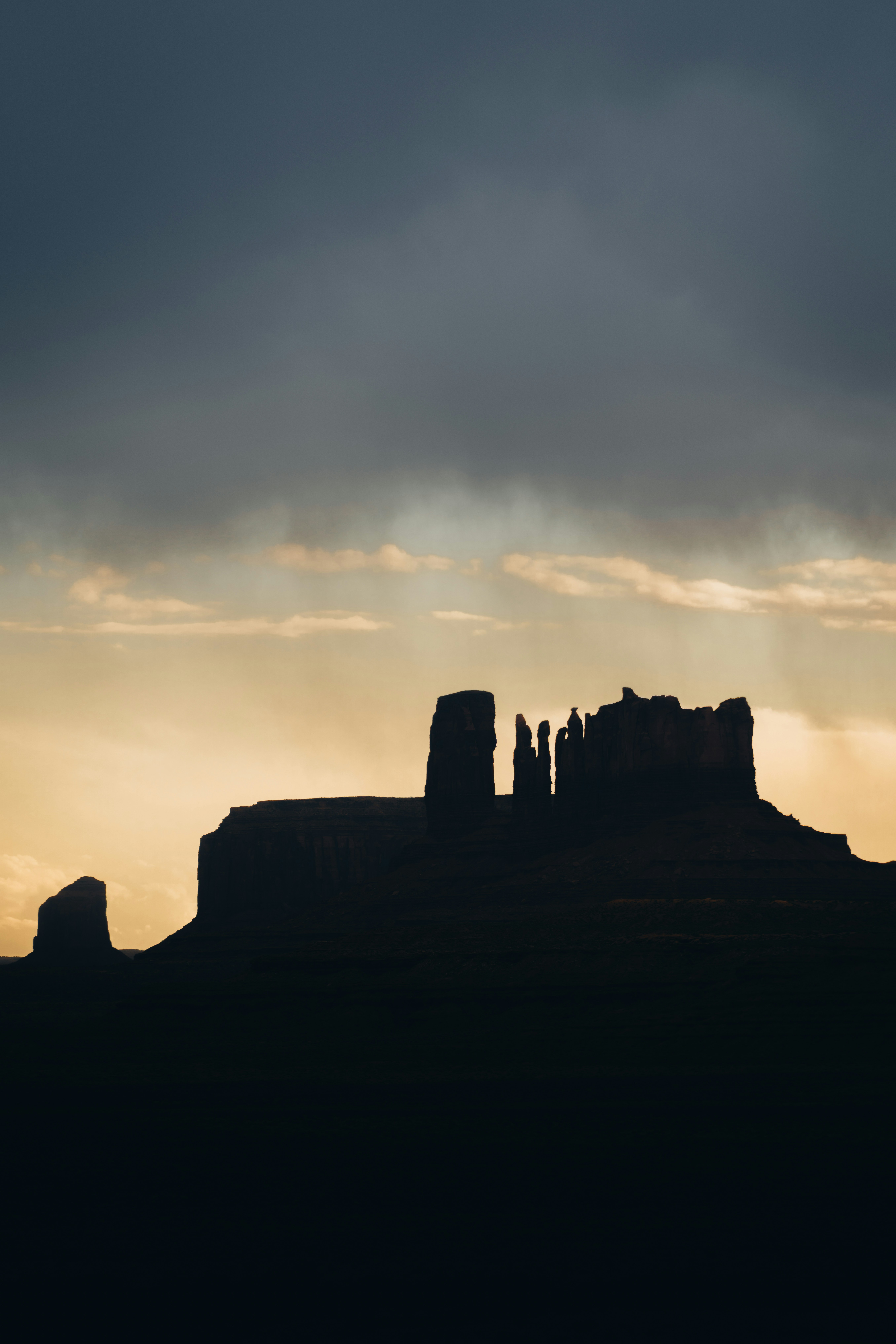 Silhouette of rock formations against a dramatic sky