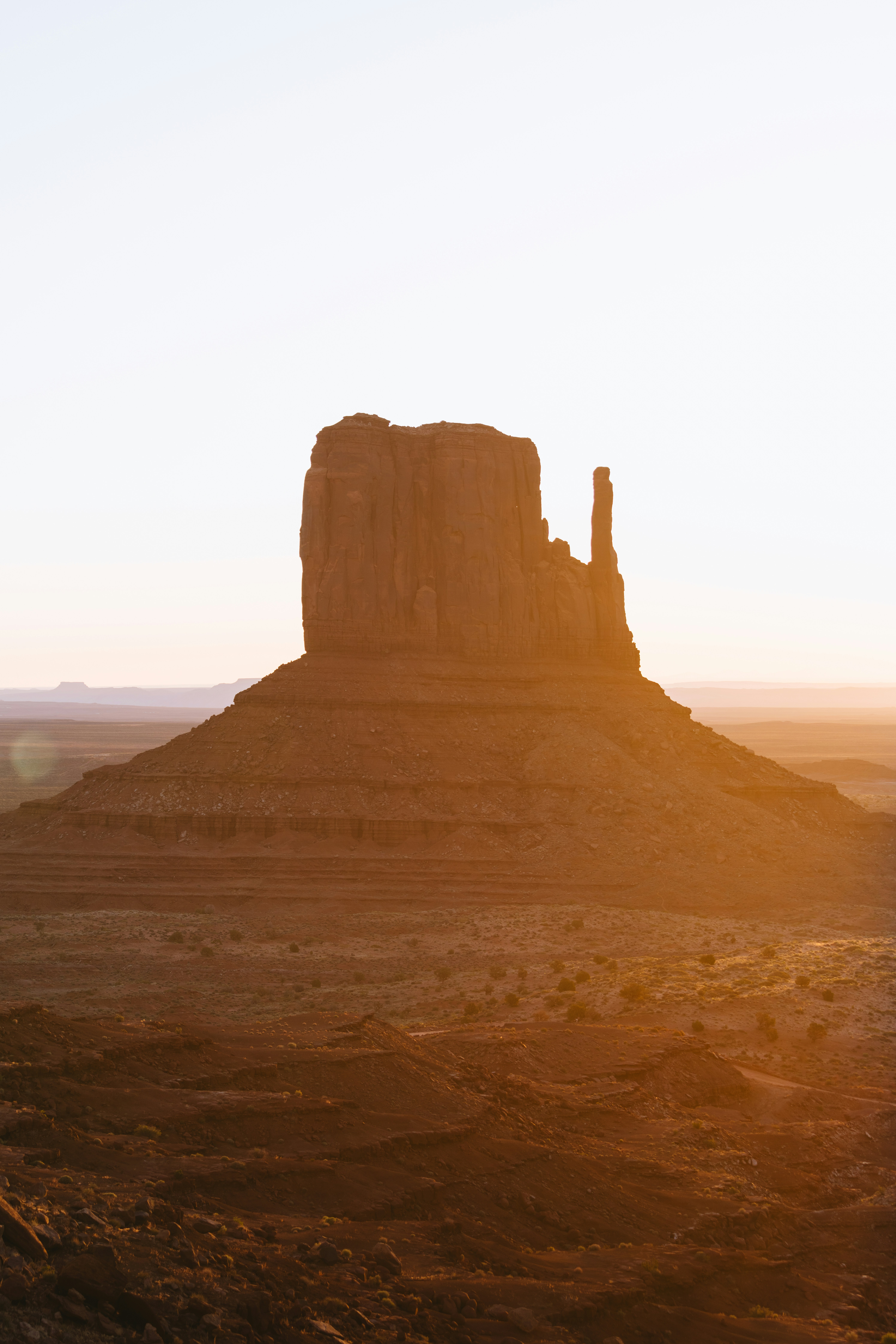 Monument valley butte bathed in warm sunset light