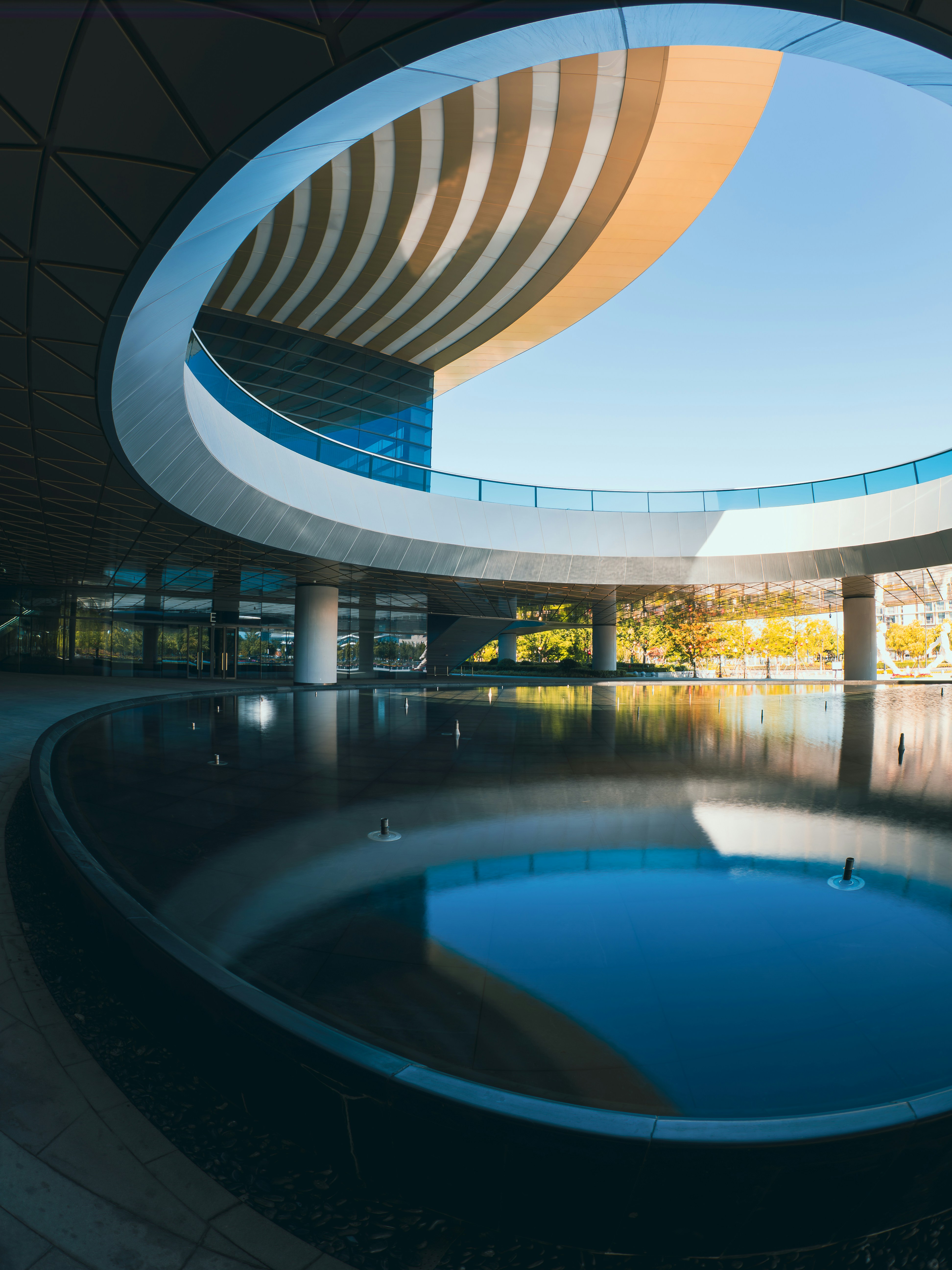 Modern architecture with circular design and water reflection