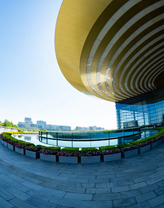 Modern building with a circular reflection pool and gardens