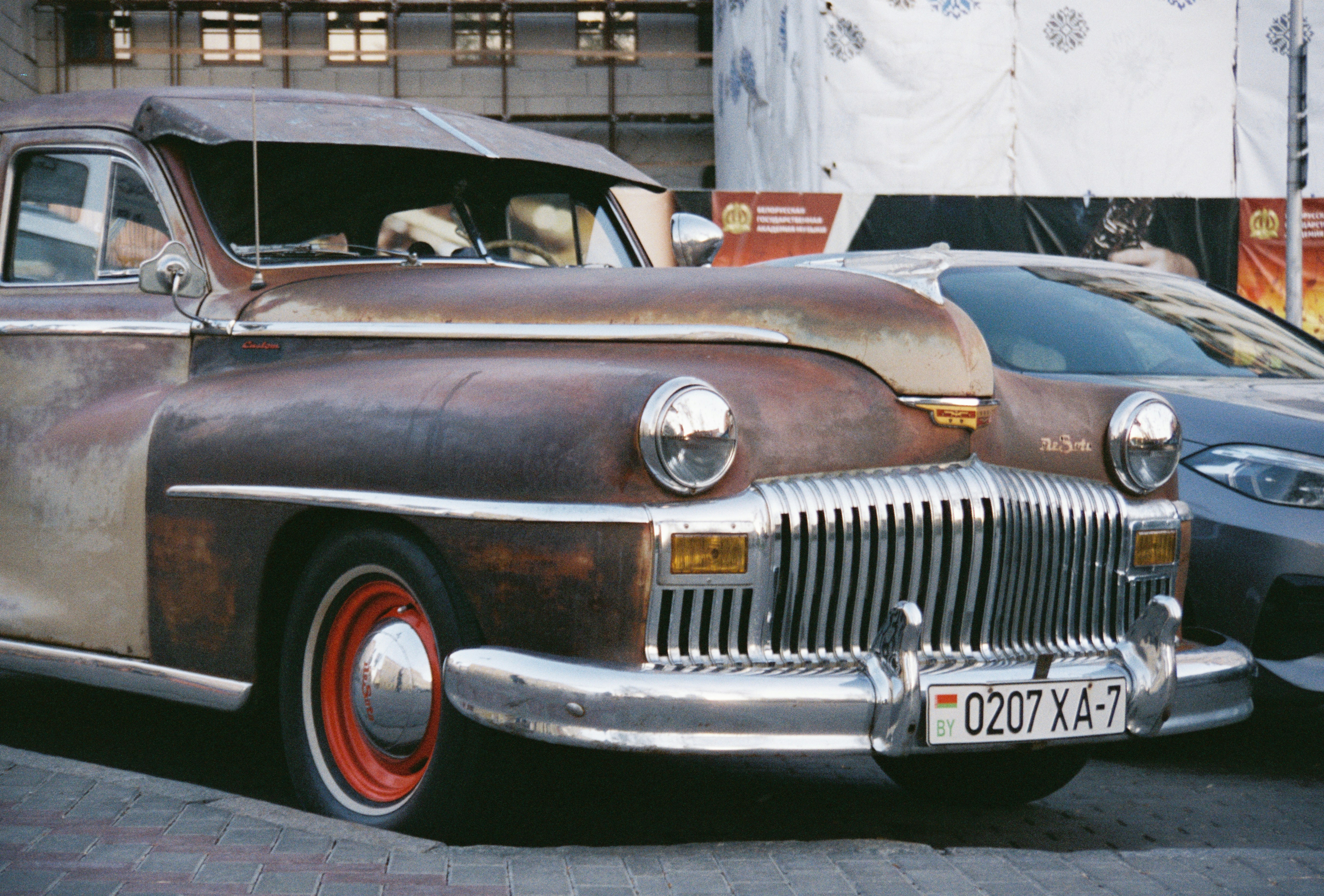 Une voiture vintage rouillée avec des détails chromés.