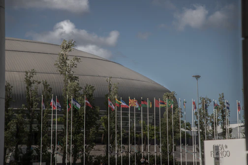 Flags outside a modern domed building