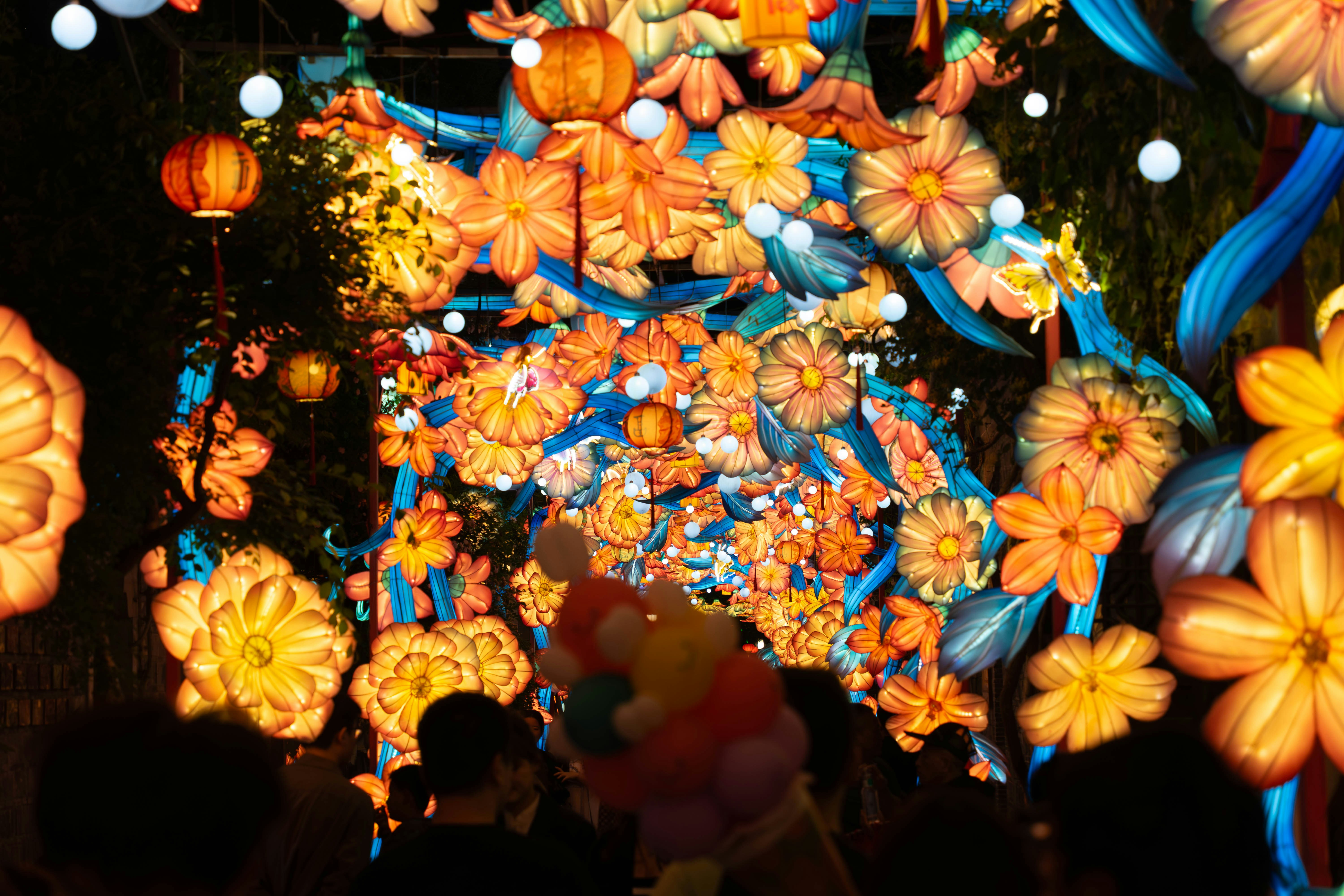 Colorful floral lanterns illuminate a night festival