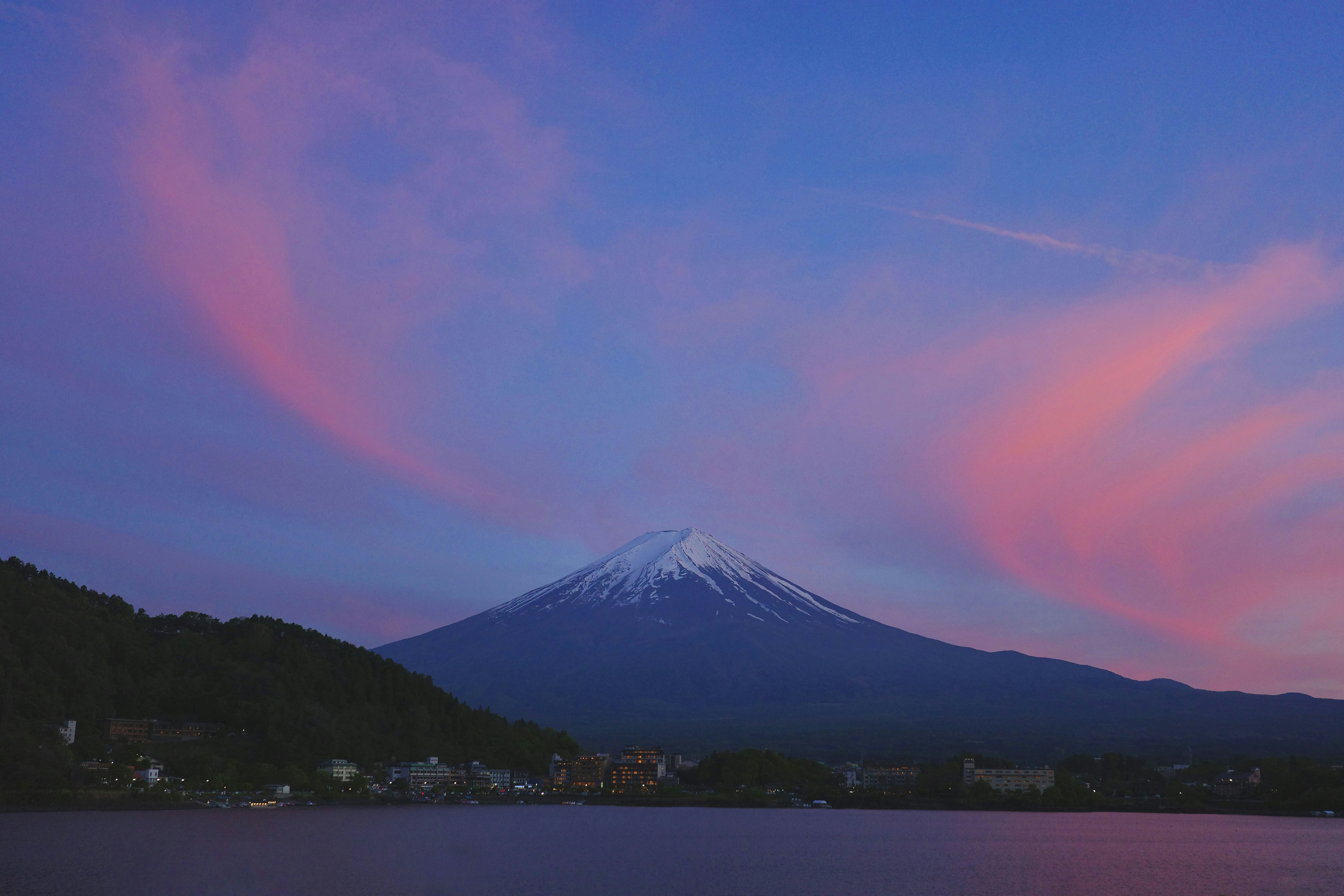 Snow-capped mountain peak under a vibrant pink and blue sky
