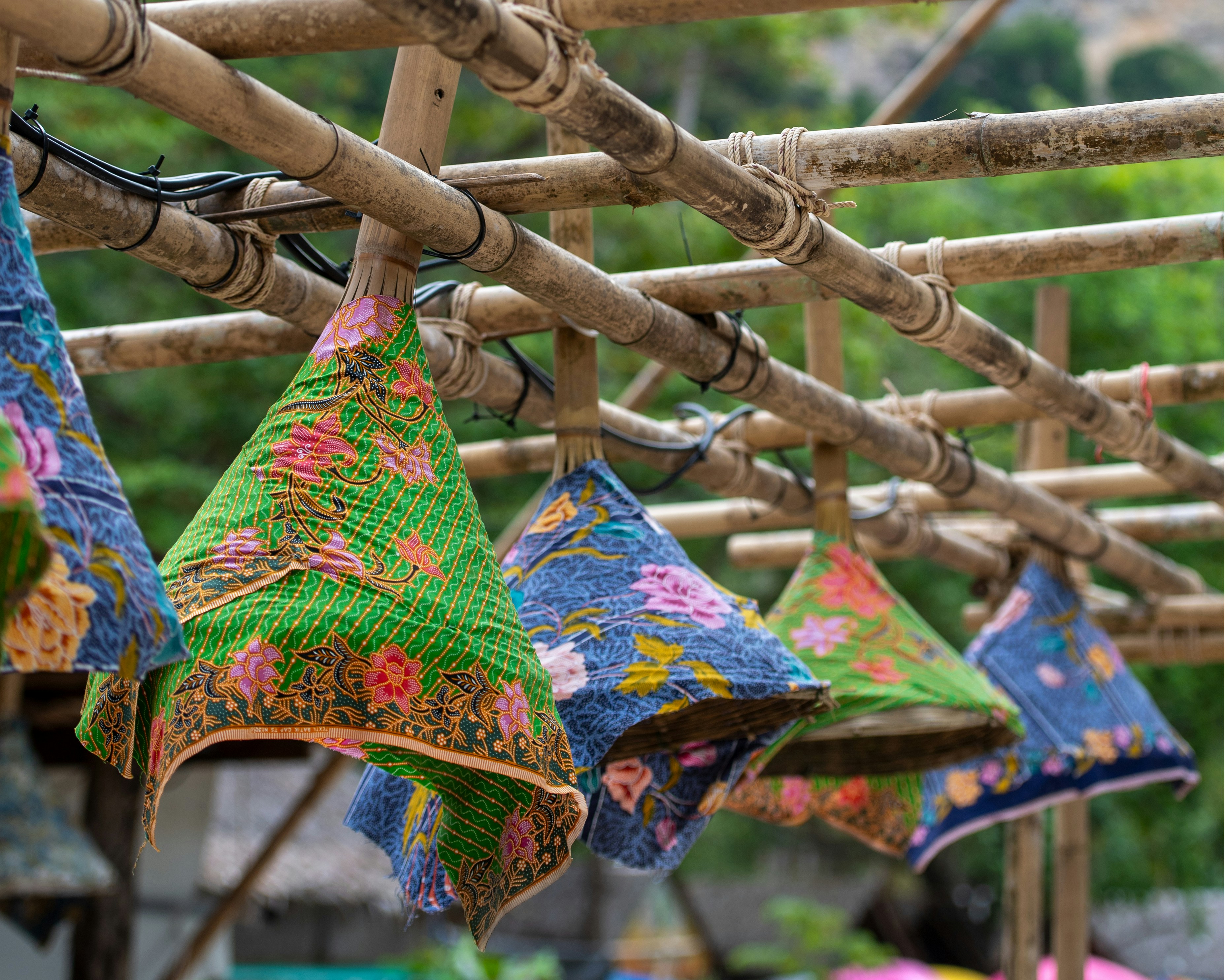Traditional Colorful Batik Fabric Covers Hanging from Bamboo Structures in Krabi, Thailand