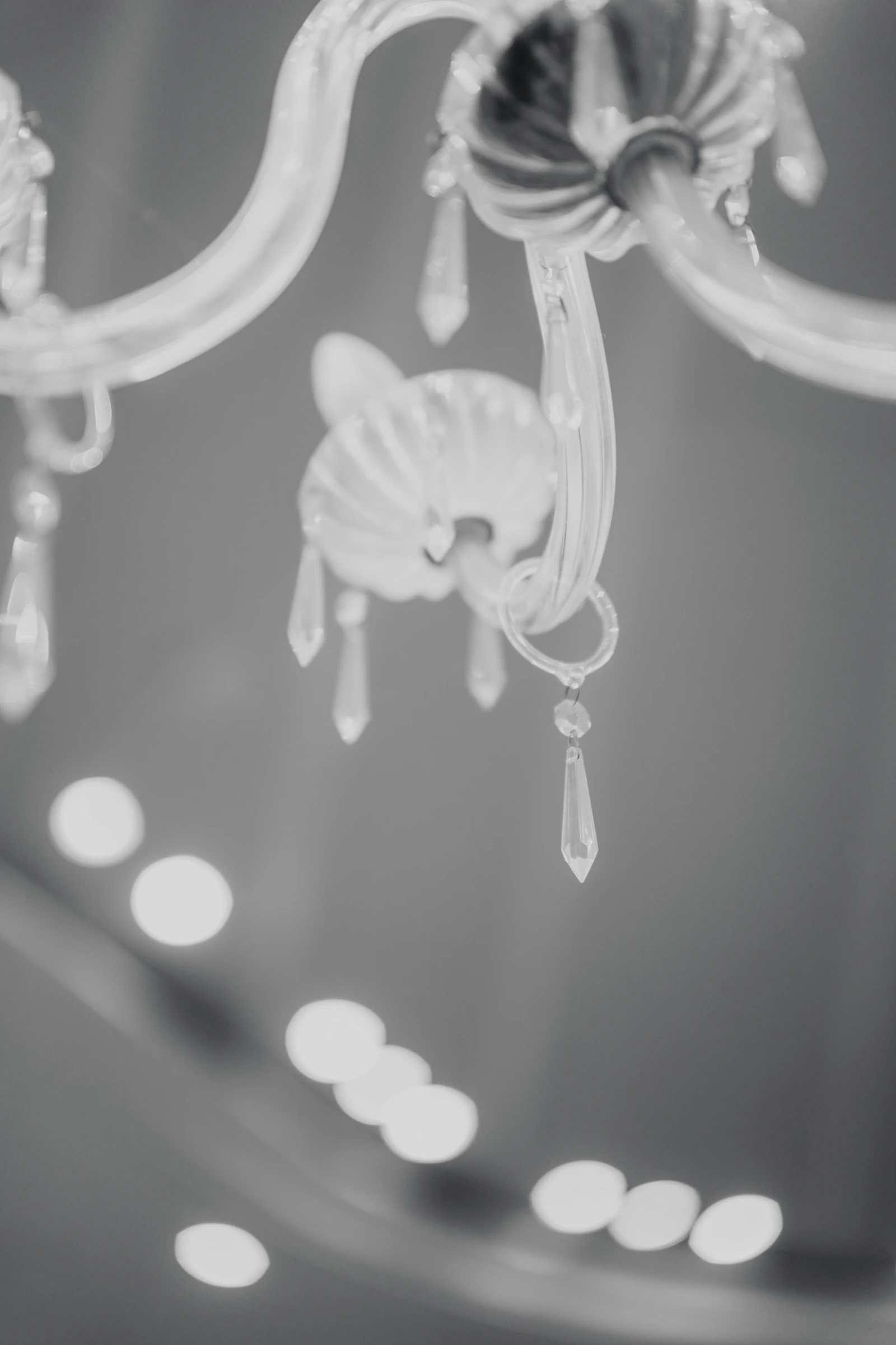A crystal chandelier in the half-light of a grand salon