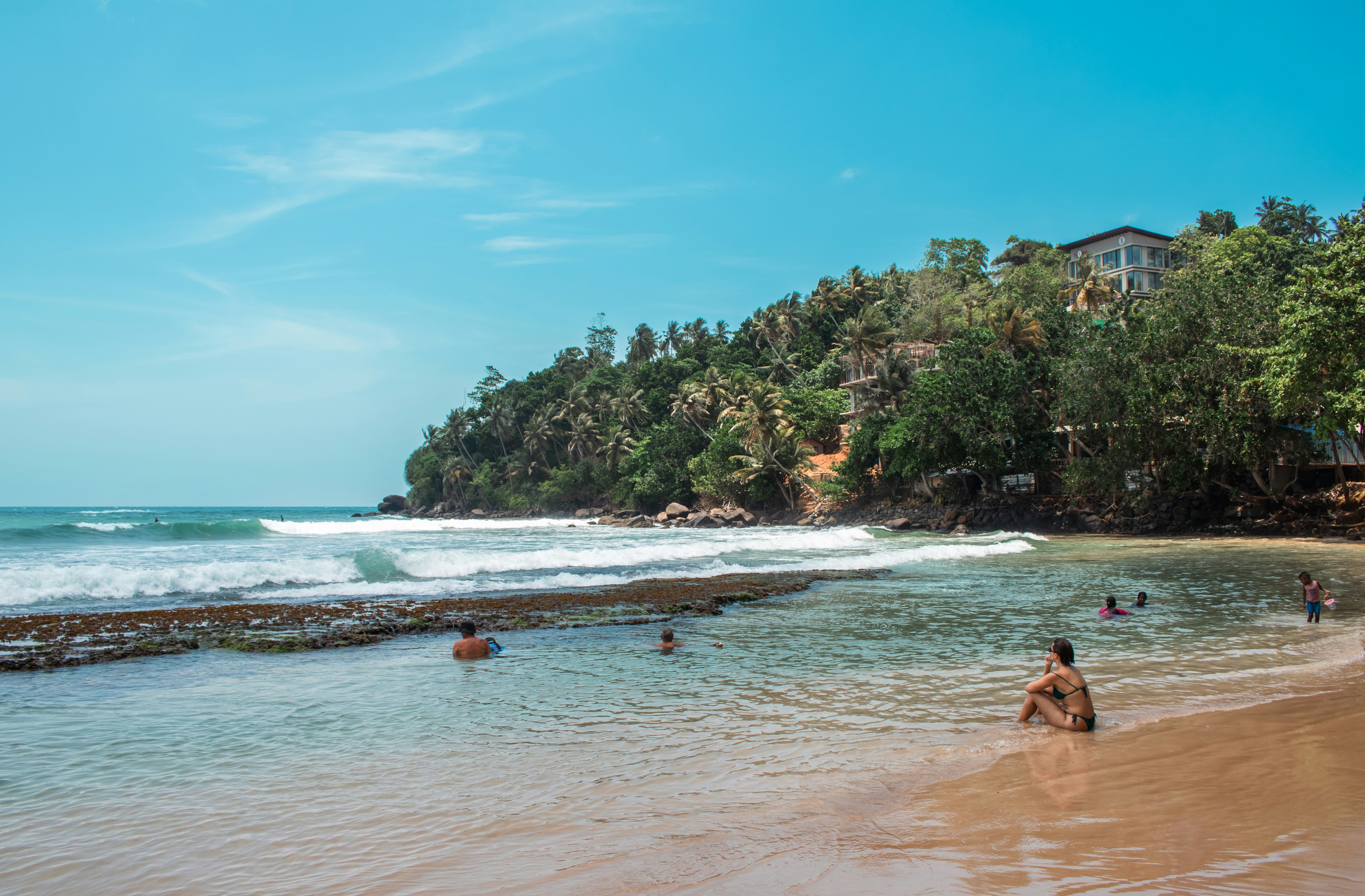 People swimming and relaxing on a tropical beach.