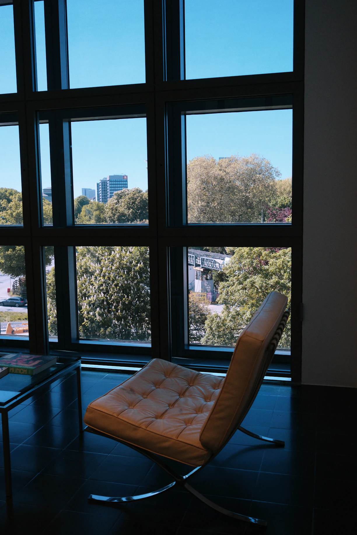 Modern armchair by a large window overlooking trees