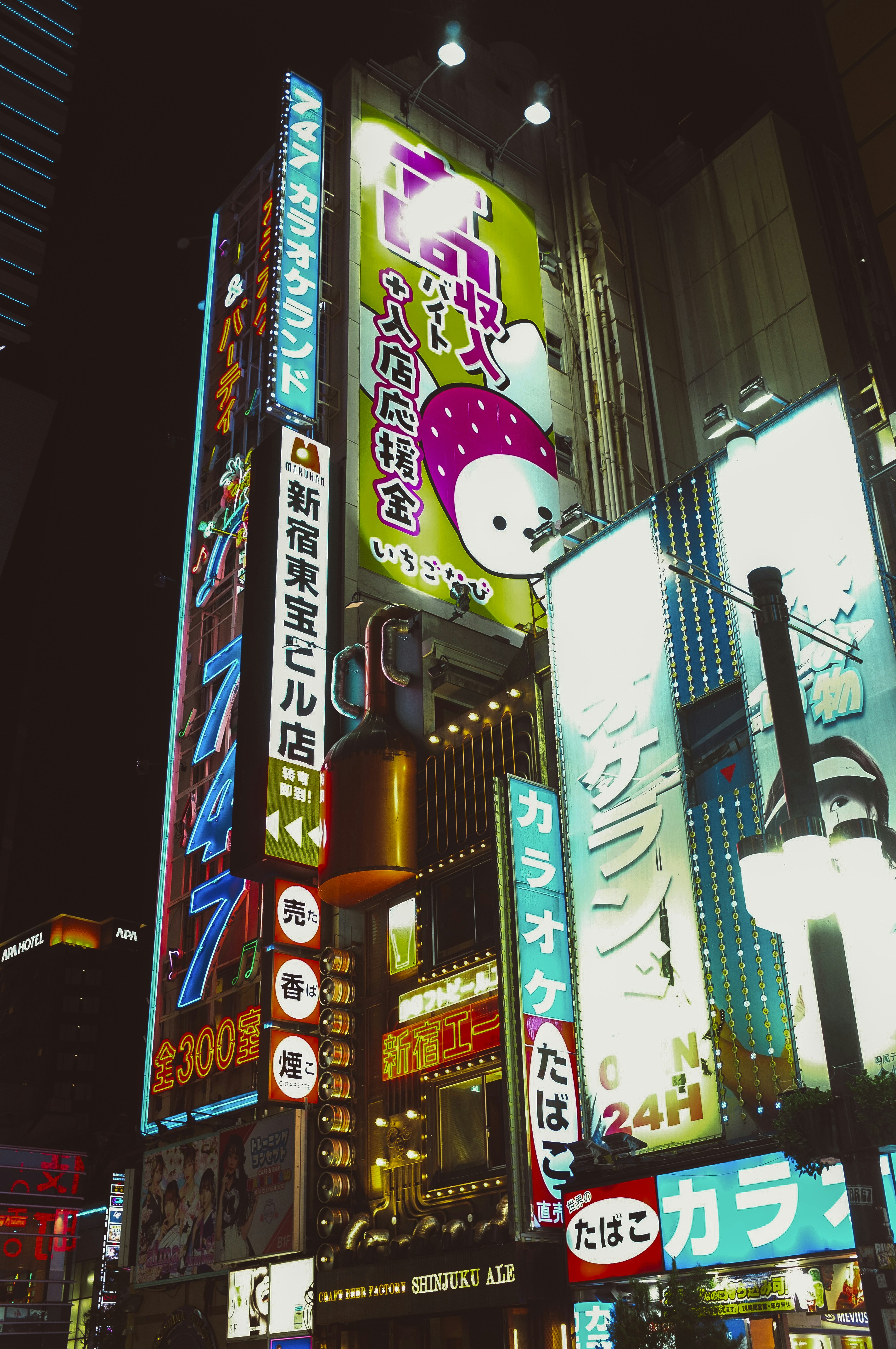 Vibrant neon signs illuminate a building at night.