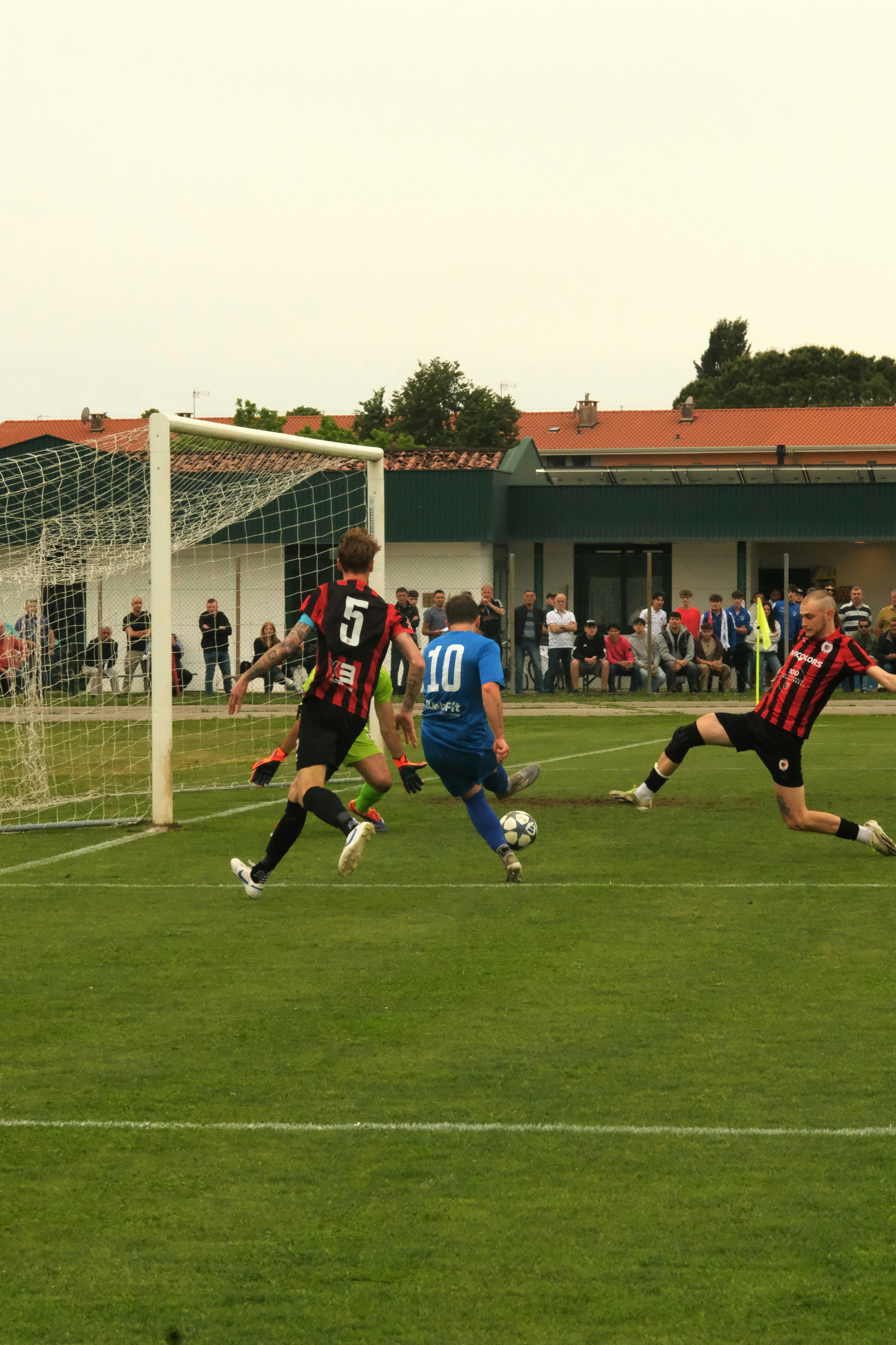 Soccer player shoots at goal during a game.