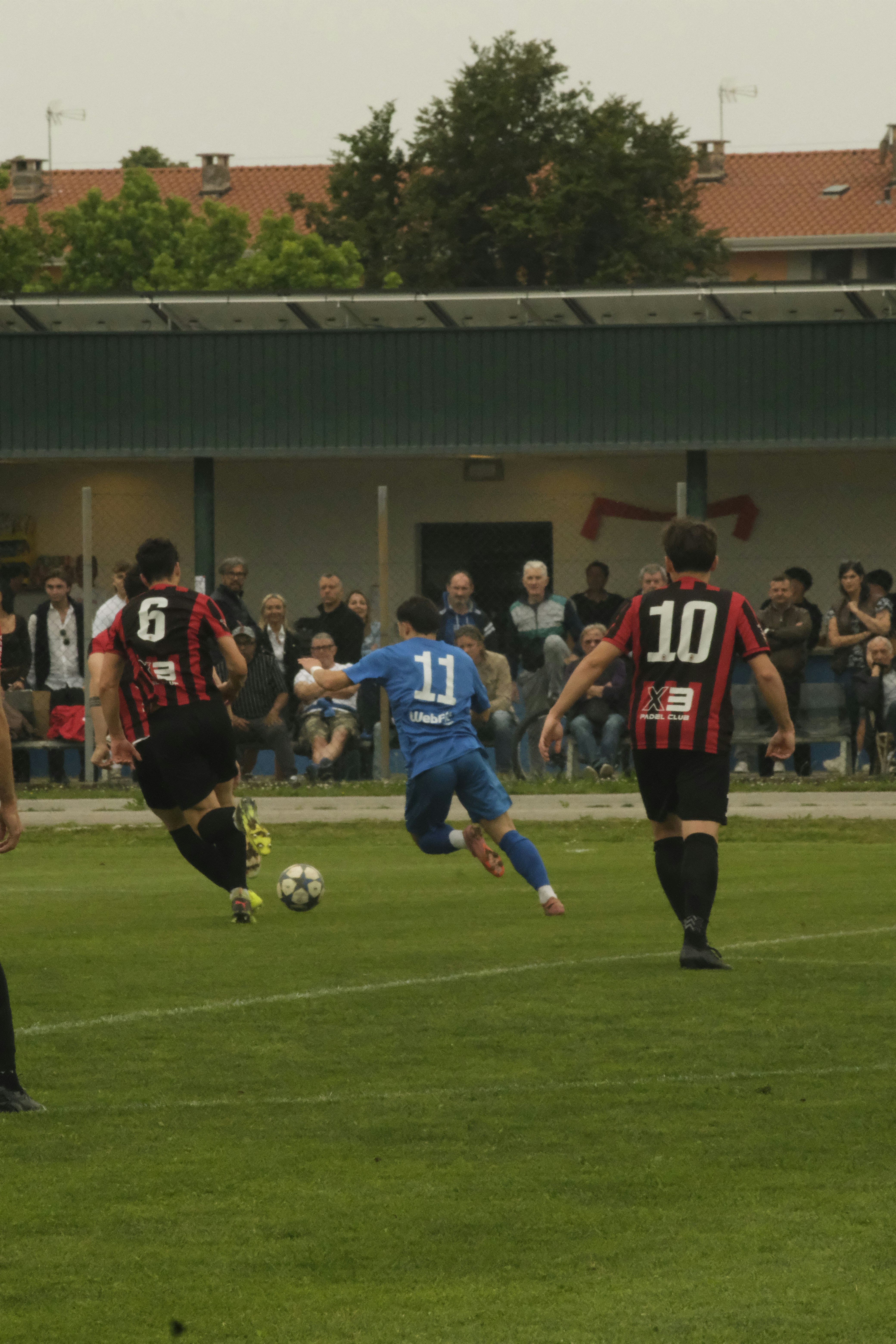 Soccer players in a game on a grassy field.