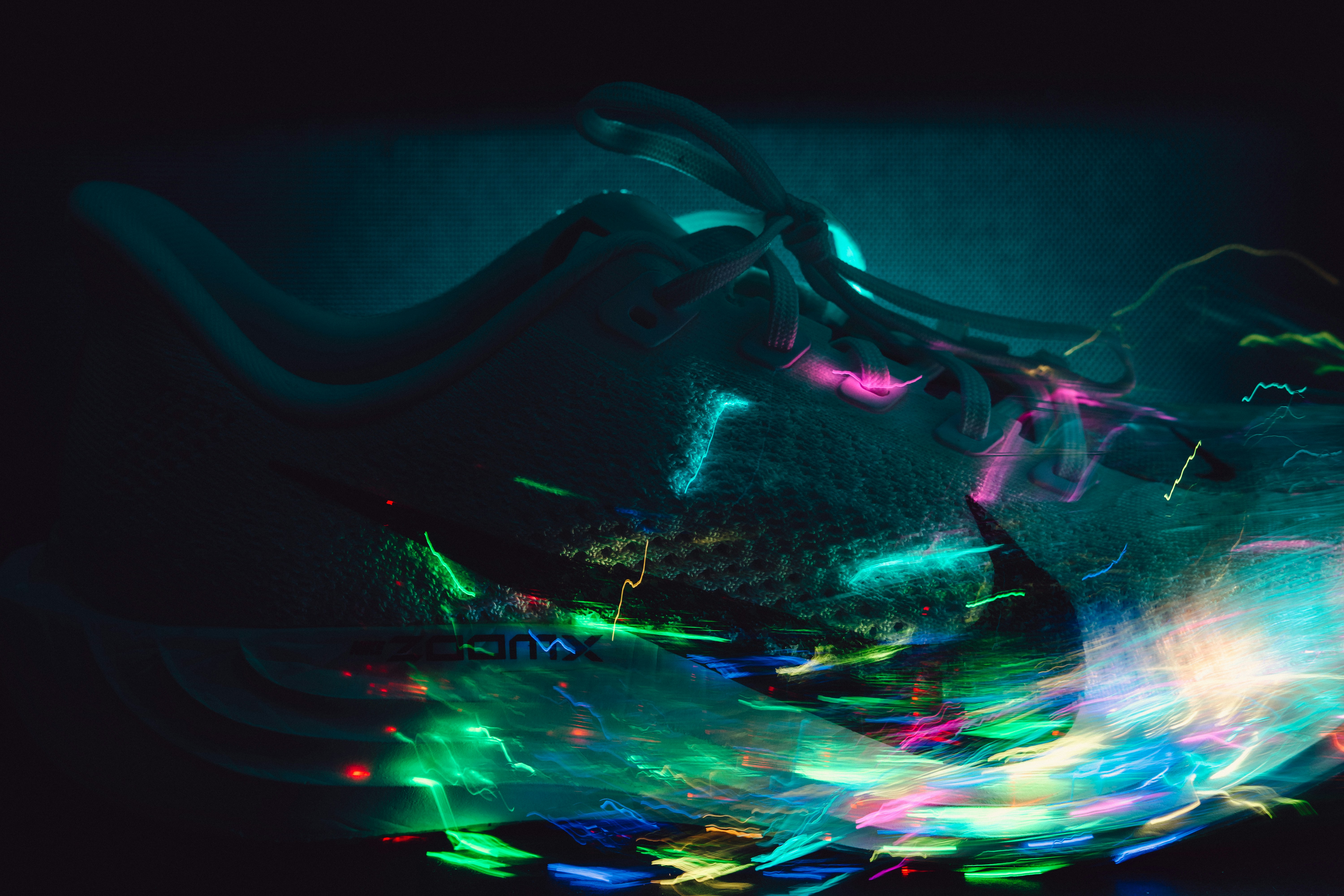 Abstract streaks of colorful lights against dark background